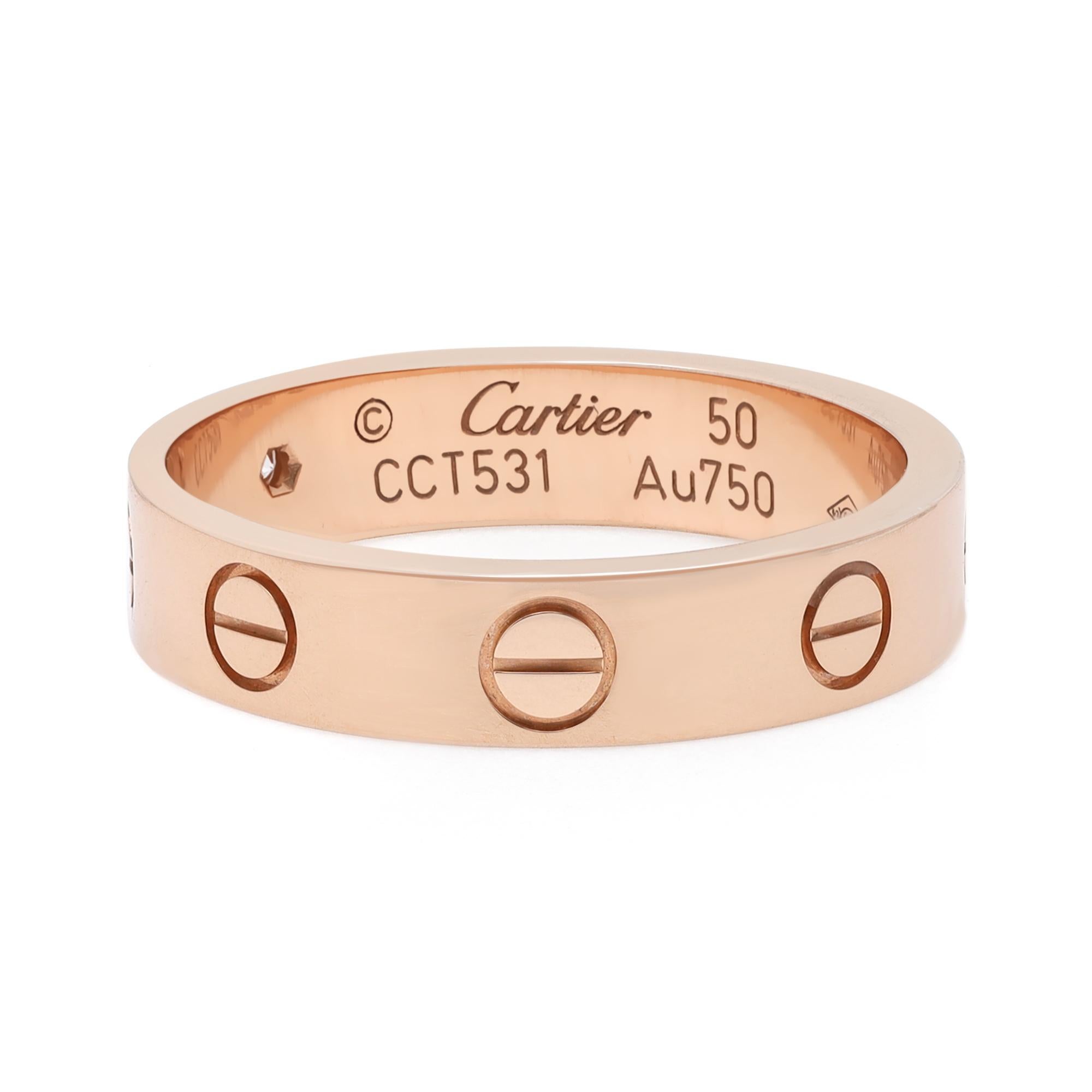 Cartier LOVE mini diamond wedding band ring. Crafted in 18k rose gold. This ring is set with 1 round brilliant cut diamond weighing 0.02 carat. Ring size: 5.5. Width: 4 mm. Excellent pre-owned condition. Comes with an original box. 