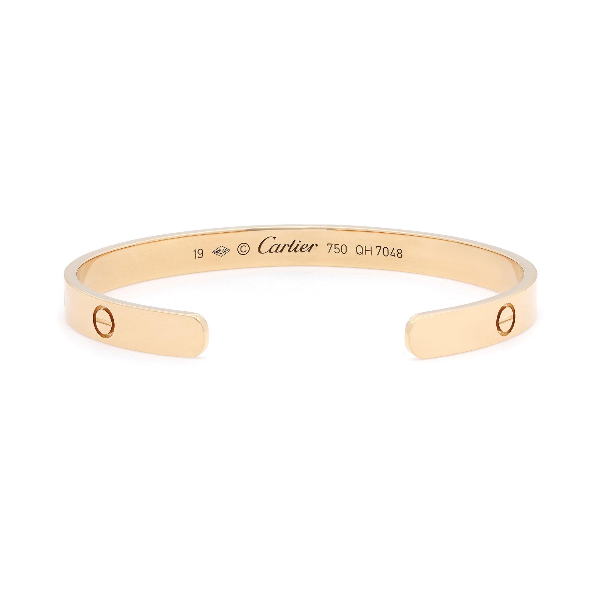 Cartier classic 18K yellow gold Love open style bracelet bangle in size 19. Width: 6.1mm. Excellent pre-owned condition. Looks unworn. Original box and paper are not included.