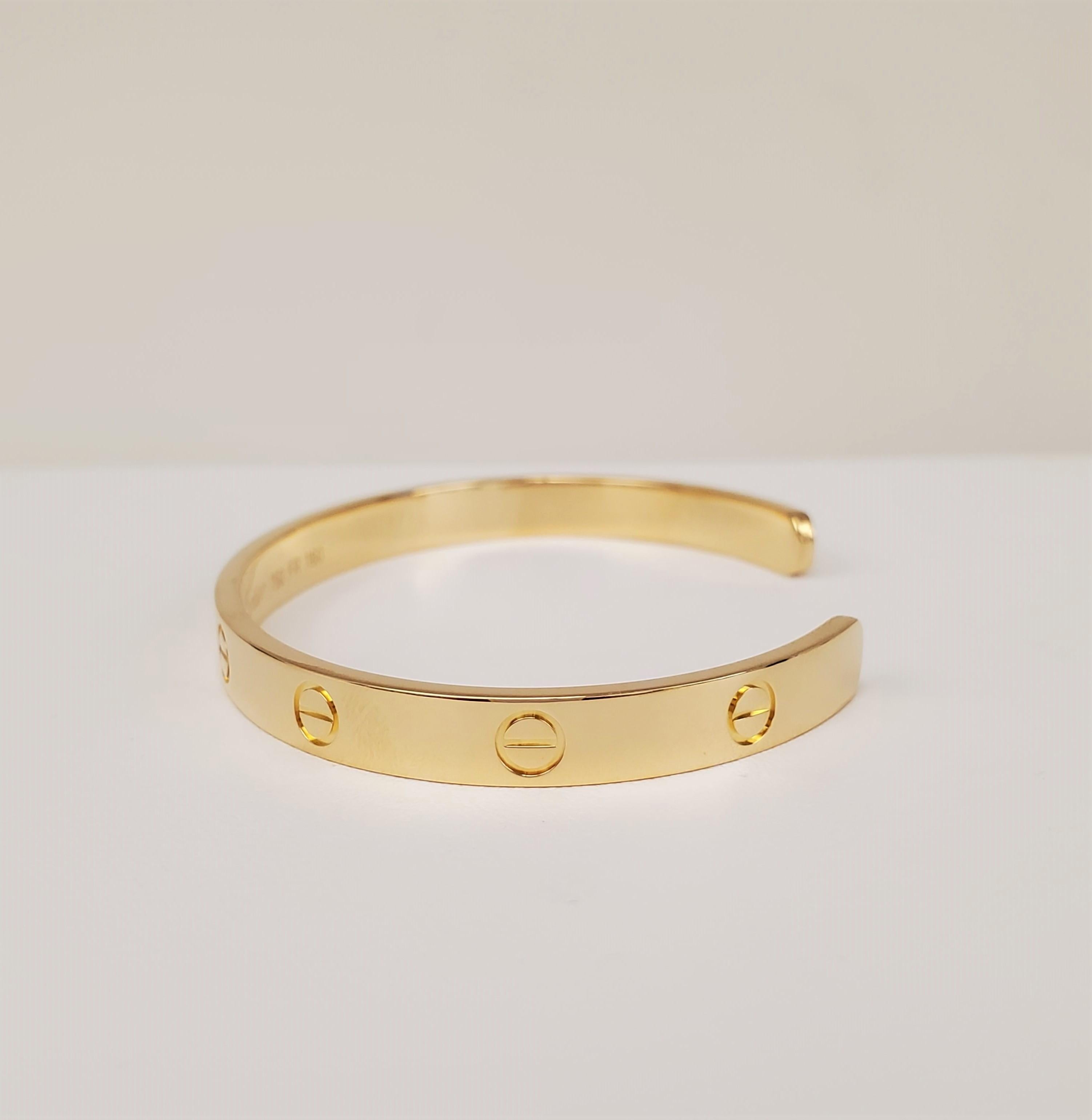 Authentic Cartier open cuff bracelet from the Love collection crafted in 18 karat yellow gold.  Signed 19, Cartier, 750, with serial number and hallmarks.  Size 19.  Does not come with box or papers.  CIRCA 2010s