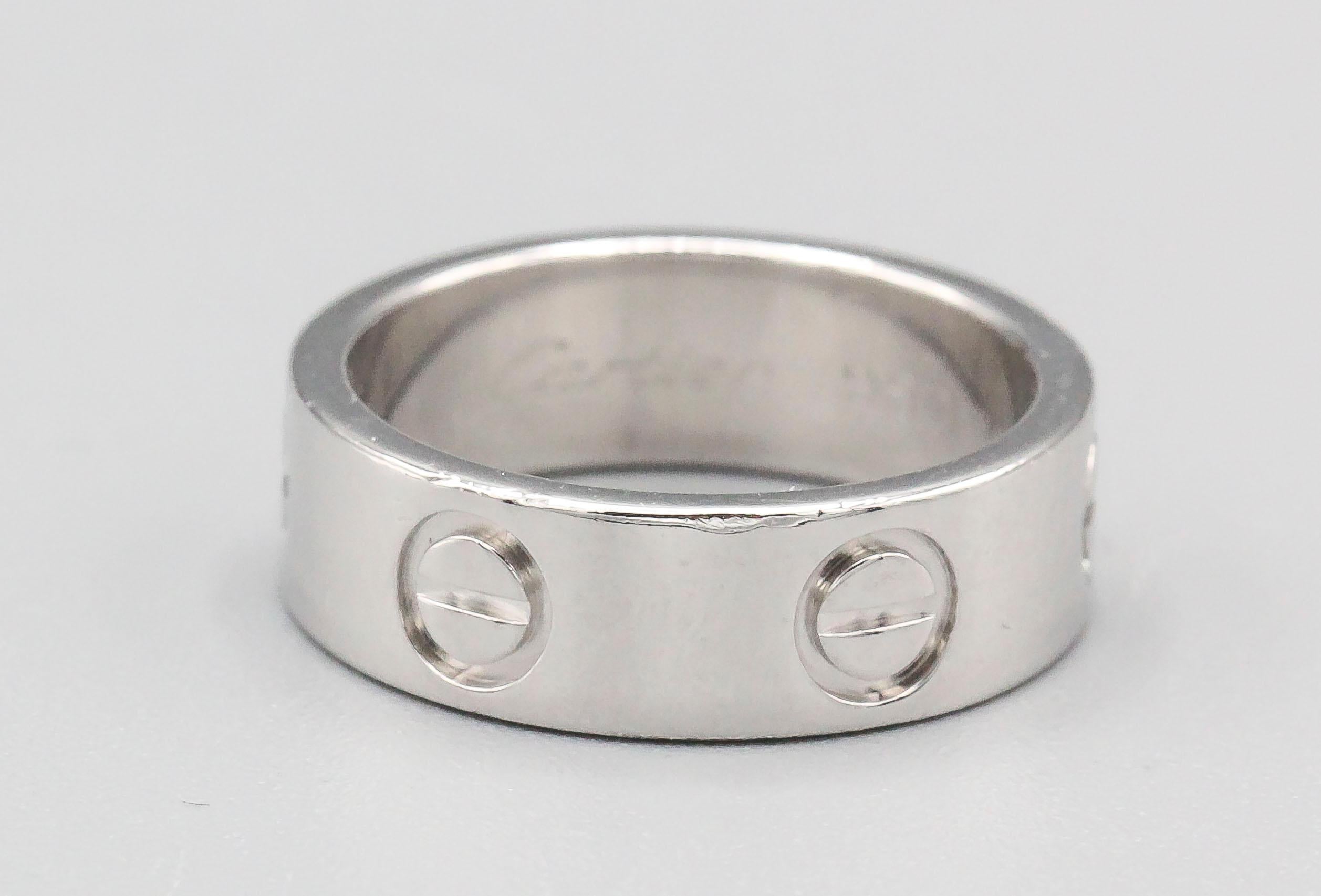 Timeless platinum band from the LOVE collection by Cartier. European size 47. 

Hallmarks: Cartier, 47, reference numbers, 950, copyright, 2001, maker's mark.