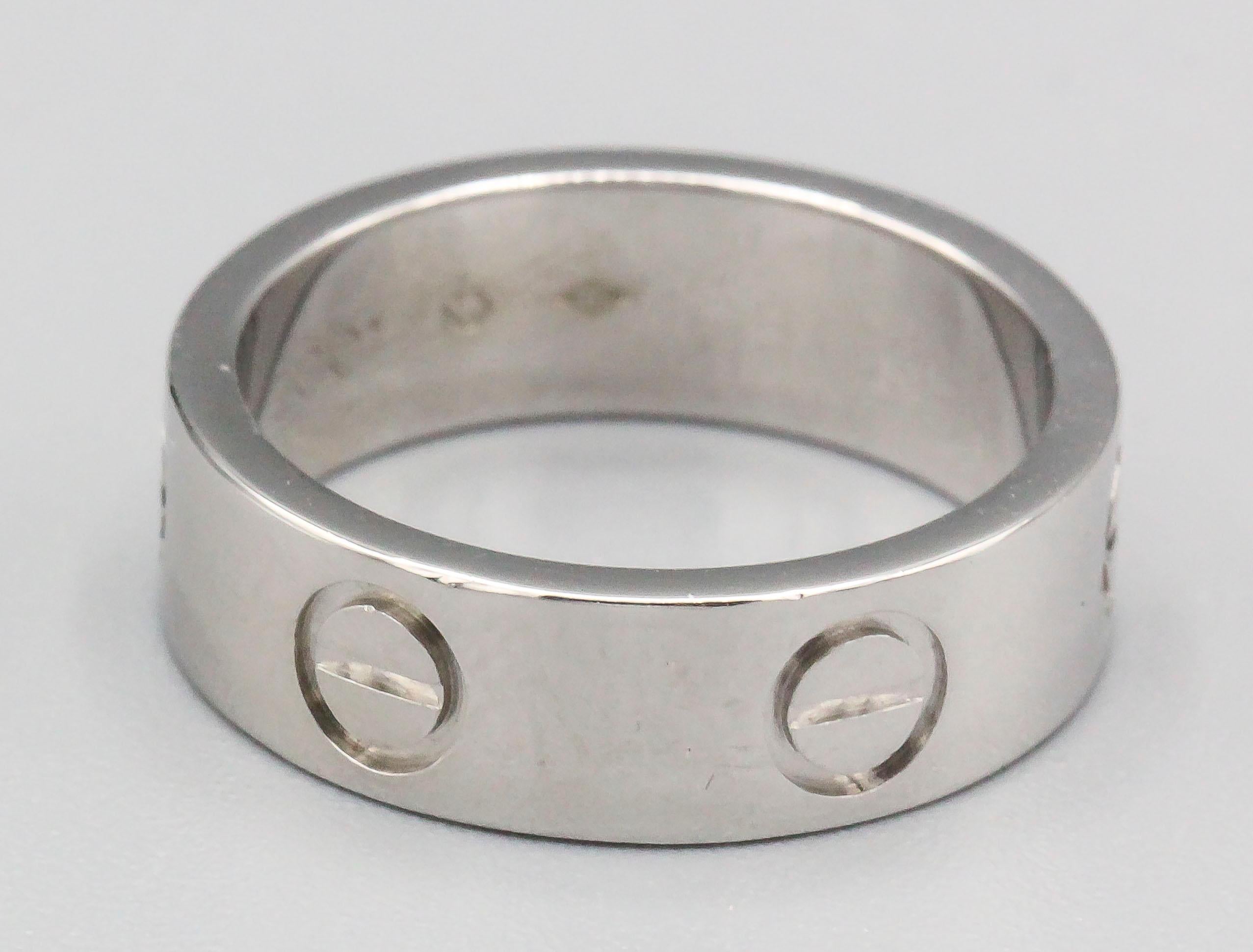 Timeless platinum band from the LOVE collection by Cartier. European size 49, US size 5.  

Hallmarks: Cartier, 49, reference numbers, 950, copyright, 2001, maker's mark.