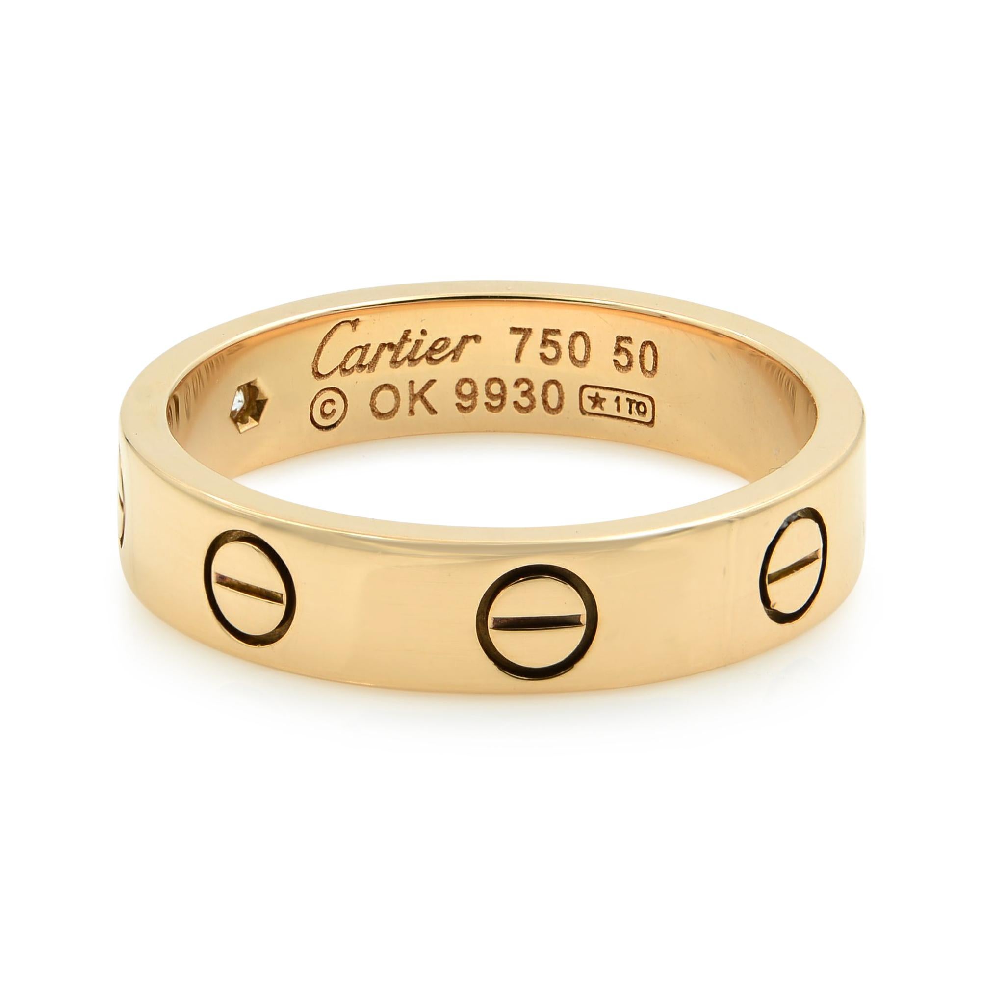 This is an authentic band ring by Cartier, this beautiful authentic designer ring is crafted from 18k rose gold with a fine polished finish and comes from Cartier's famous LOVE collection in the mini style. It is a piece of absolute style and