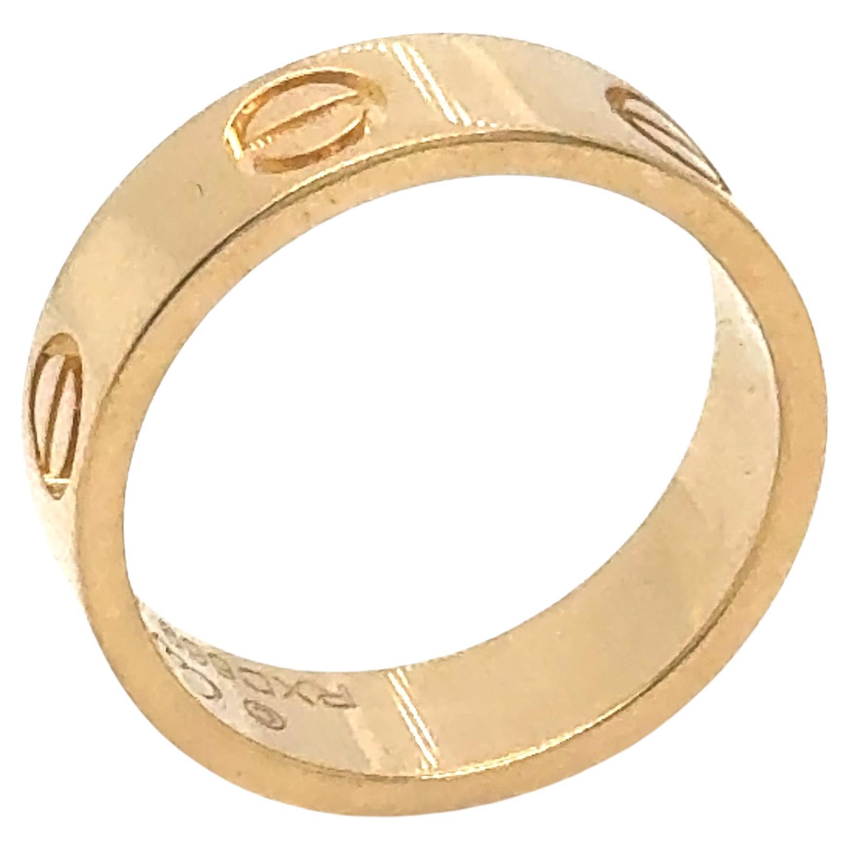 Cartier Love ring in 18K yellow gold. The ring is a size 51 U.S. size 5 3/4 with serial RXD---. Ring is fully hallmarked by designer 