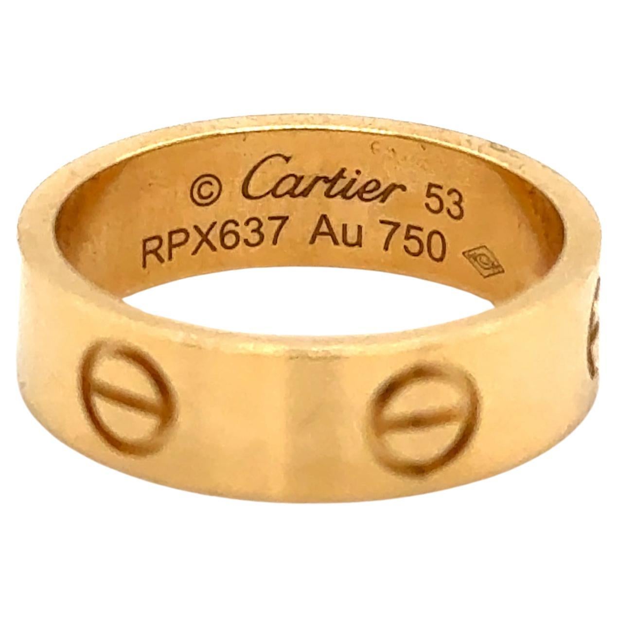 Cartier Love ring in 18K yellow gold. The ring is a size 53 U.S. size 6.25 with serial RPX---. Ring is fully hallmarked by designer 
