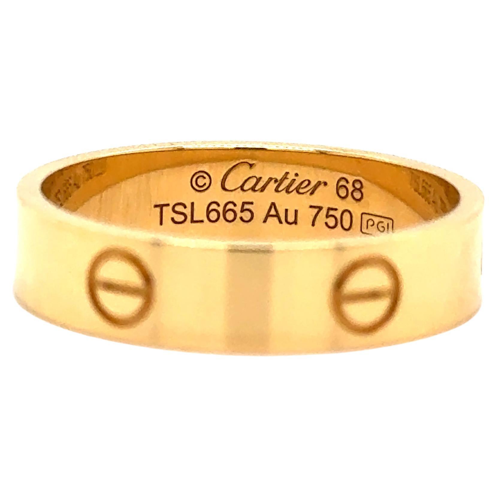 Cartier Love ring in 18K yellow gold. The ring is a size 68 U.S. size 12 1/4 with serial TSL---. Ring is fully hallmarked by designer 