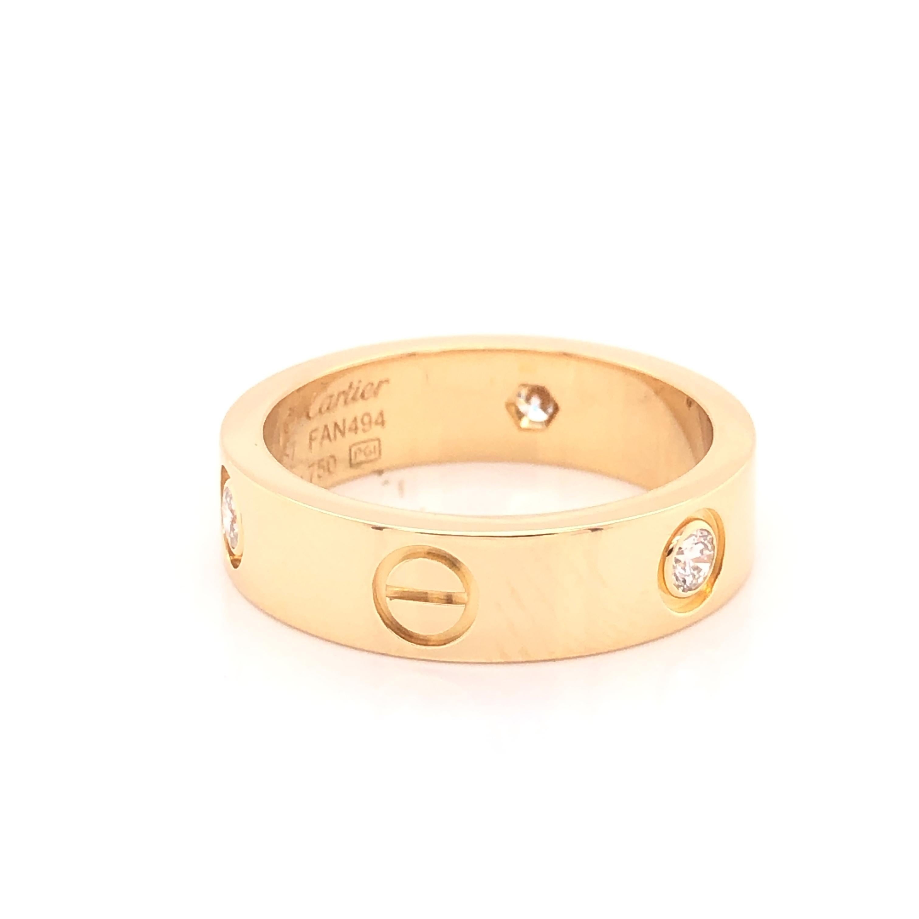Love ring, 18K yellow gold, set with 3 brilliant-cut diamonds totaling 0.22 carats. 
The ring is a size 57 U.S. size 8 with serial FAN---. Ring is fully hallmarked by designer 