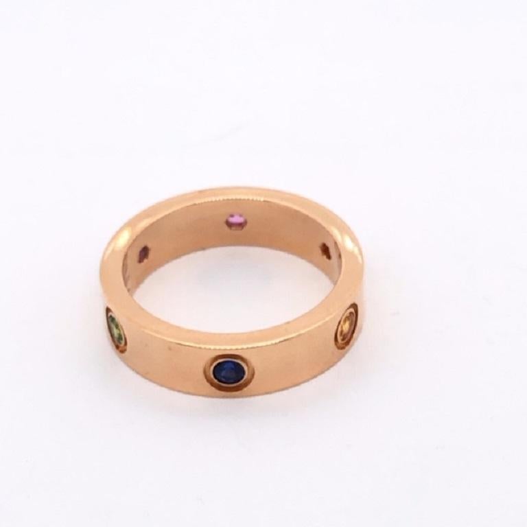 Love ring, 18K rose gold, set with 1 rose sapphire, 1 blue sapphire, 1 yellow sapphire, 1 green garnet, 1 orange garnet and 1 amethyst. Width: 5.5mm. 
Cartier Ring Size: 59 