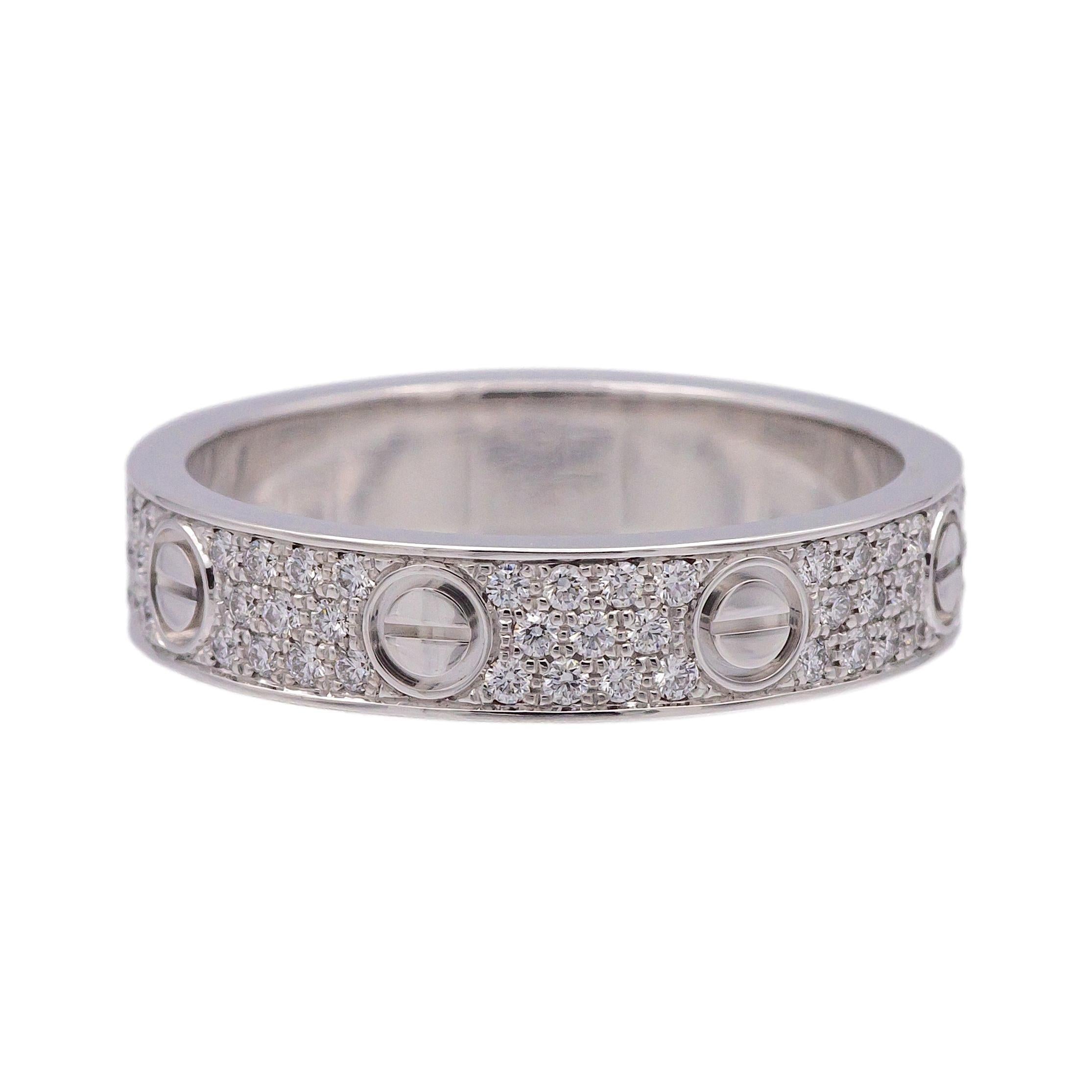 This original Cartier Love Ring is crafted in 18K white gold and features pavé-set diamonds totaling approximately 0.30 carats.  The ring is in excellent condition, and is properly hallmarked with the Cartier logo, metal content, maker's mark, and