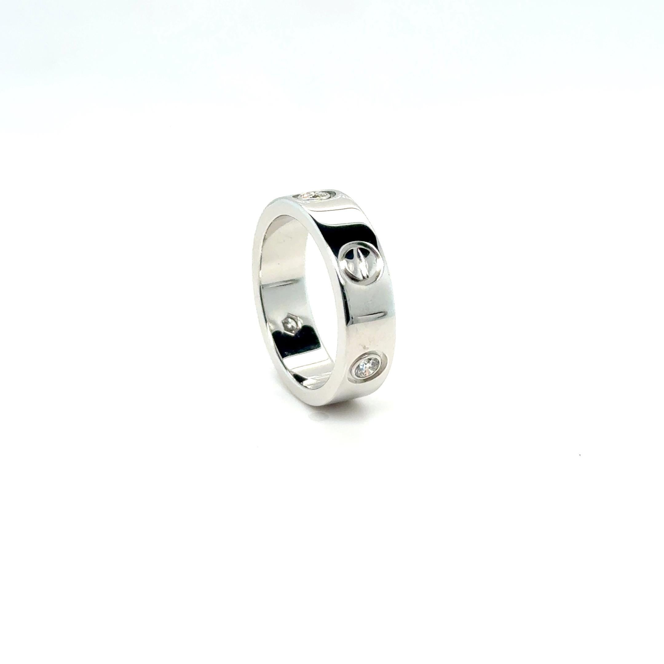 This exquisite Cartier ring from the Love Collection is crafted from 18 Karat white gold and features three brilliant diamonds. The iconic screw motifs around the band add a distinctive touch, while the diamonds enhance its elegance and sparkle.