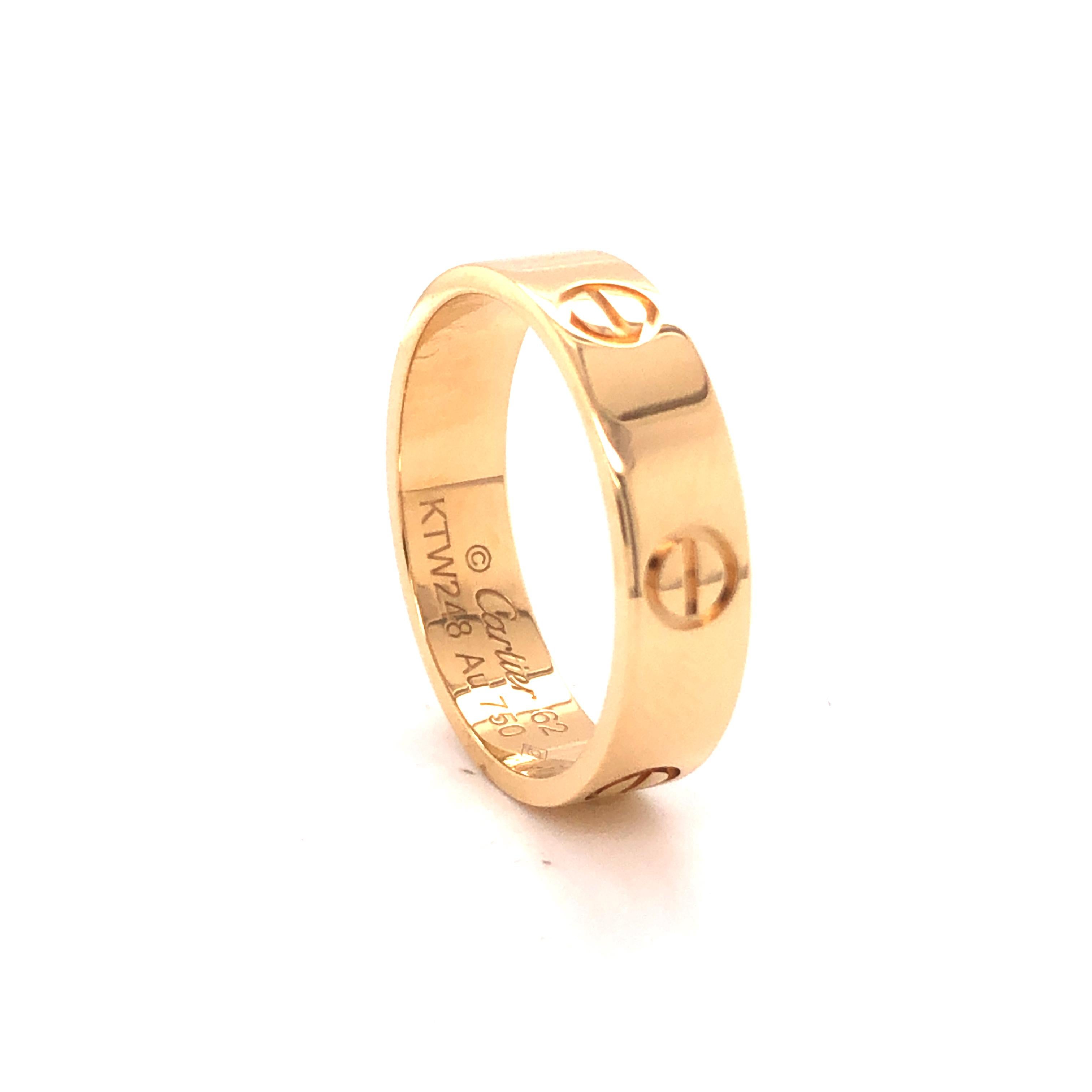 Cartier Love ring in 18K yellow gold. The ring is a size 62 U.S. size 10 with serial KTW---. Ring is fully hallmarked by designer 