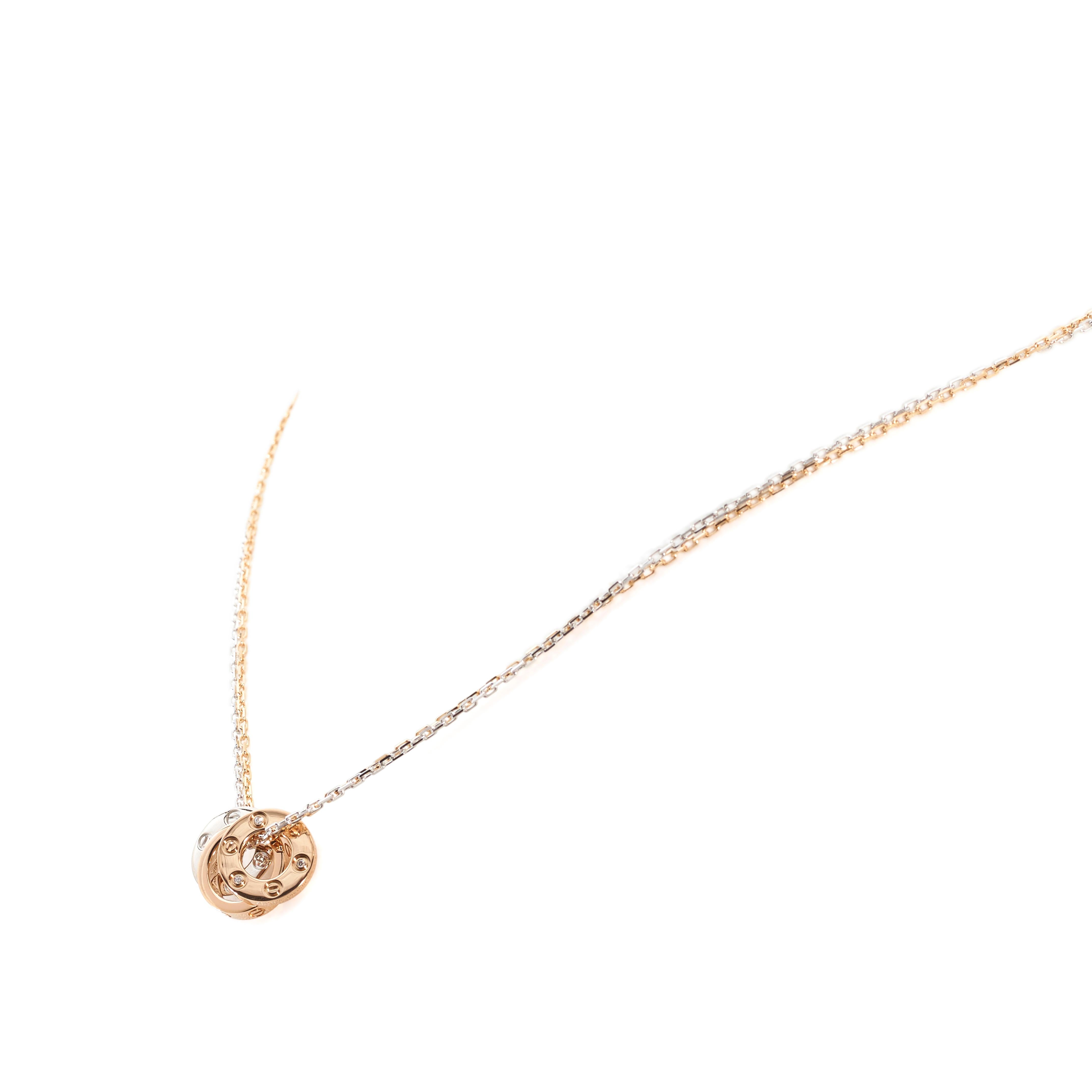 Authentic Cartier Love necklace comprised of a delicate double chain crafted in 18 karat rose and white gold.  Three Love charms are situated on the chain to complete the look.  The two mini circle charms, one rose gold and one white gold, are each