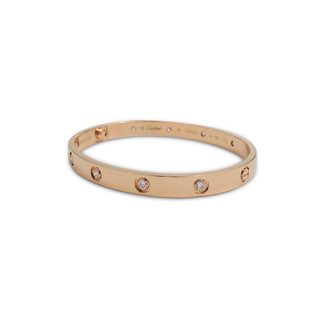 Authentic Cartier 'Love' bangle bracelet crafted in 18 karat rose gold set with ten round brilliant cut diamonds (E-F in color, VS clarity) weighing an estimated 0.96 carats total. Signed Cartier, size 18, Au750, with serial number. The bracelet is