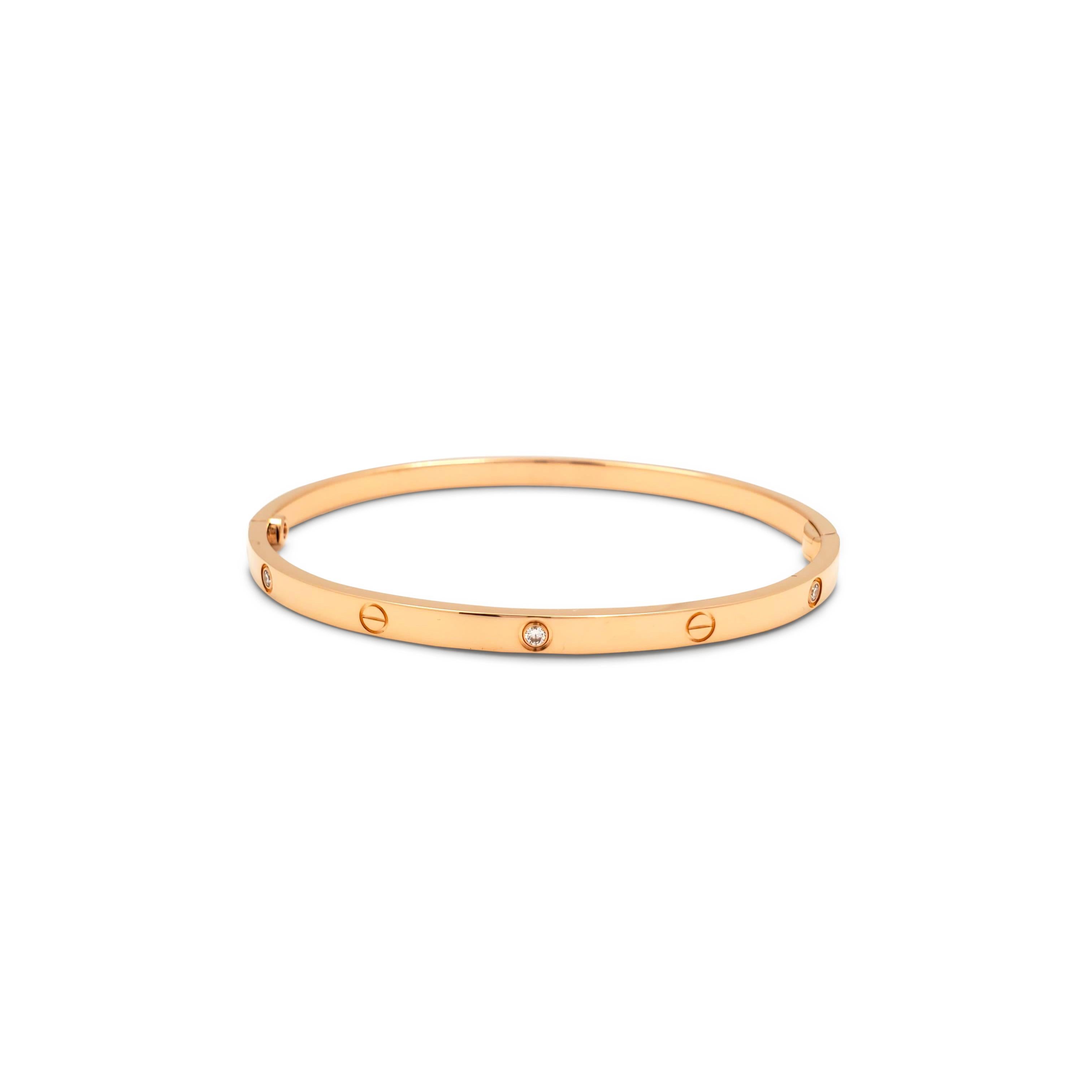 Authentic Cartier 'Love' bracelet crafted in 18 karat rose gold is set with six round brilliant cut diamonds (E-F, VS) weighing approximately 0.15 carats total. Size 17.  Signed Cartier, Au750, 17, with serial number and hallmark. The bracelet is