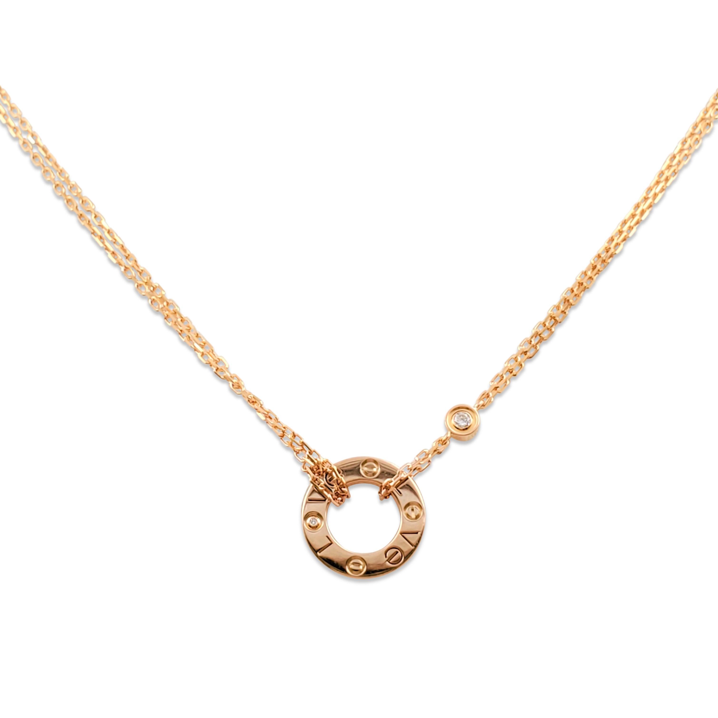 Authentic chain and ring charm necklace from the Cartier 'Love' collection. Crafted in 18 karat rose gold, the double-strand oval-link chain features a half-inch round ring and screw top motifs set with two round brilliant cut diamonds (E-F color,