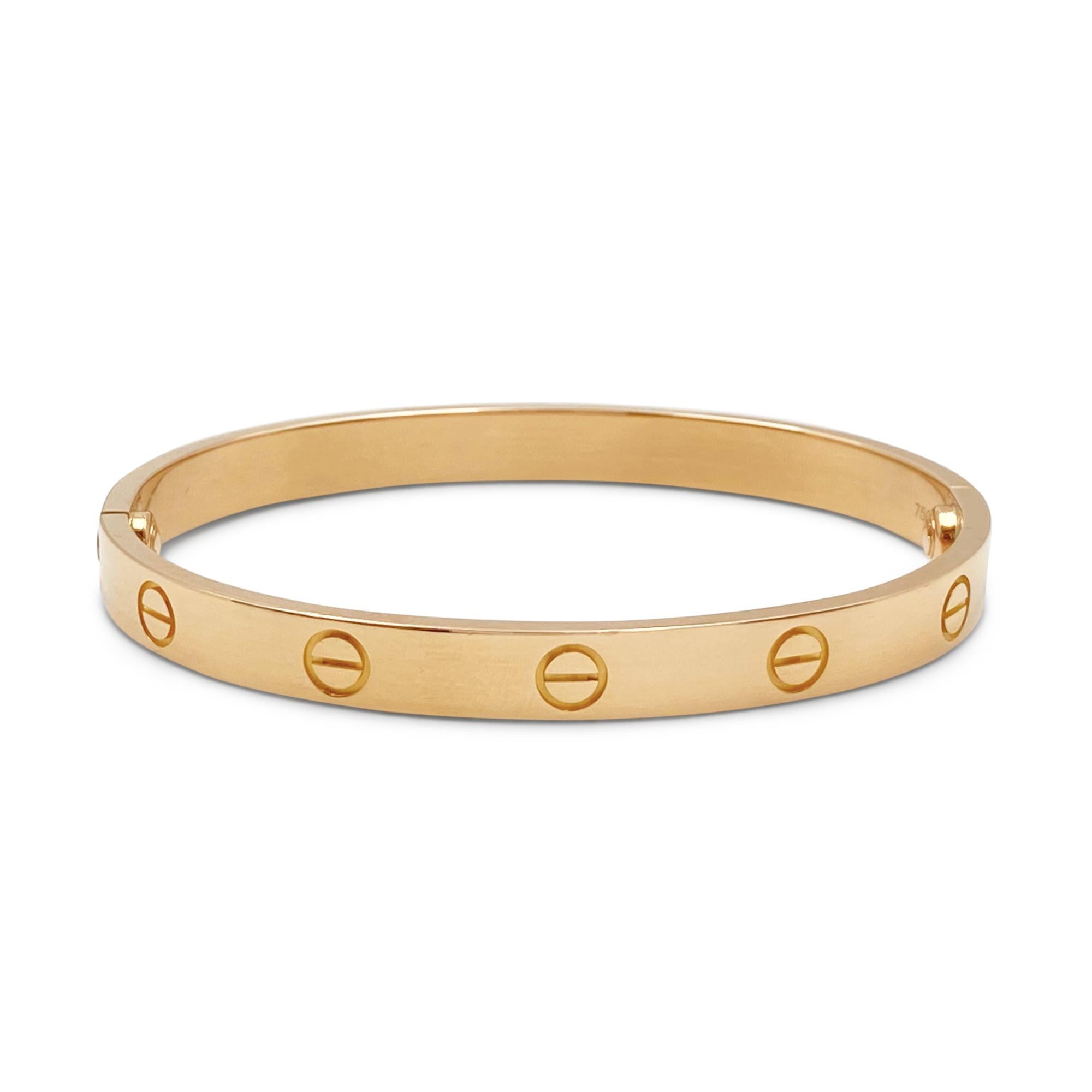 Authentic Cartier 'Love' bracelet crafted in 18 karat rose gold. Size 17. Signed Cartier, 17, 750, with serial number and hallmarks. New screw system with Cartier enhancement for added security.  The bracelet is presented with a Cartier pouch and