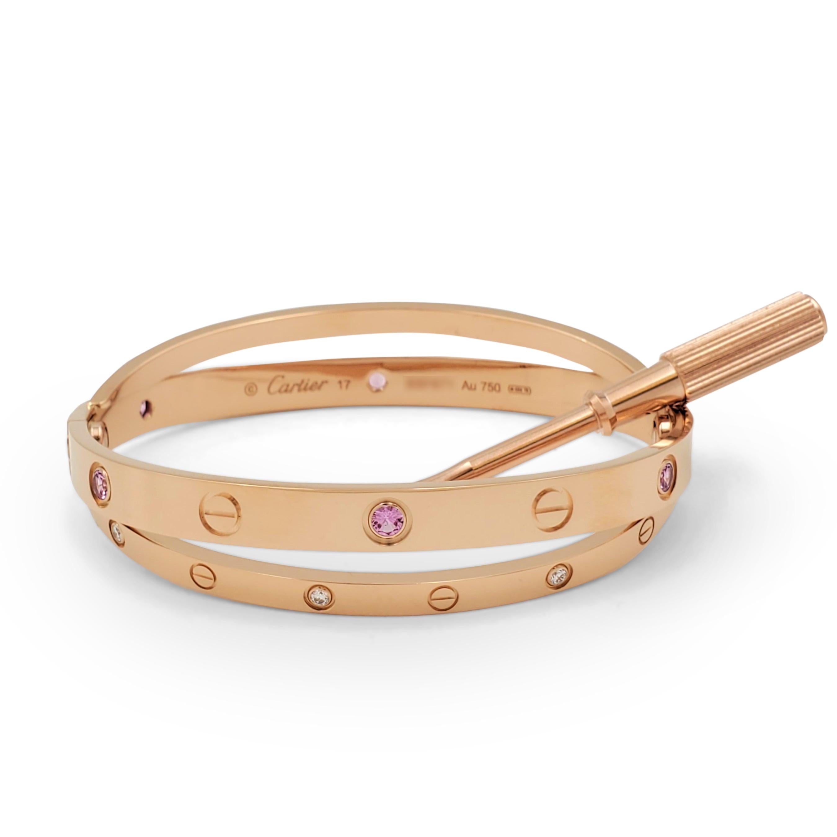 Authentic Cartier 'Love' bracelet comprised of crisscrossing bands of 18 karat rose gold. The bracelet is set with high-quality round brilliant diamonds (E-F, VS)  and vibrant pink sapphire stones. Signed Cartier, Au750, 17 with serial number. The