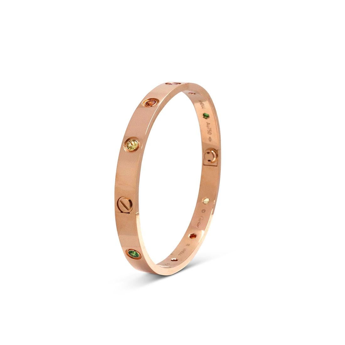 Authentic Cartier 'Love' bracelet crafted in 18 karat rose gold. The bracelet is set with 2 pink sapphires, 2 yellow sapphires, 2 green garnets, 2 orange garnets and 2 amethysts. Size 18. Signed Cartier, 18, Au750, with serial number and hallmarks.