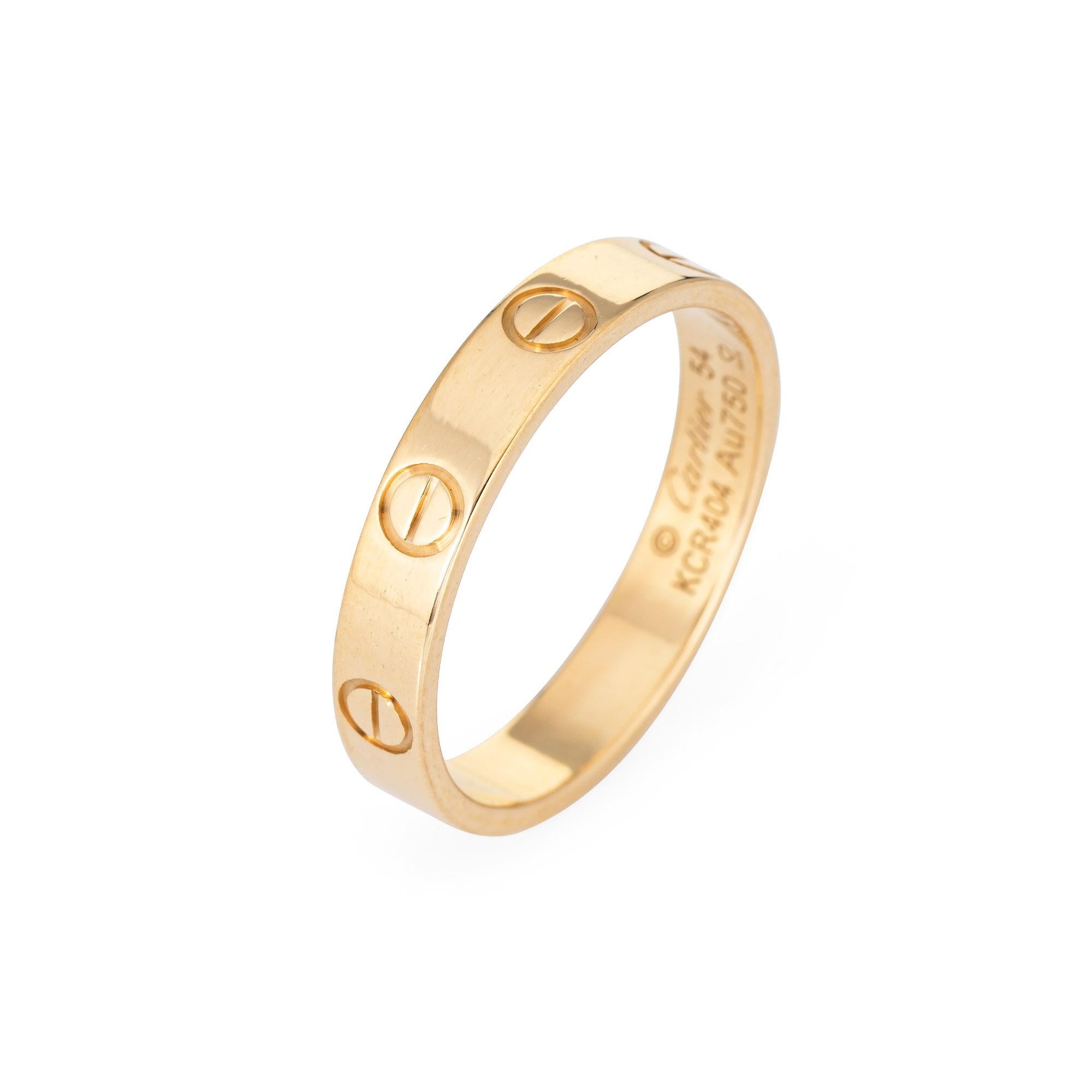 Cartier LOVE wedding band crafted in 18k yellow gold (current collection).  

The iconic Cartier ring features the classic screw motif to a 3.6mm wide band.  The ring is great worn alone or layered with your fine jewelry from any era. 

The ring is