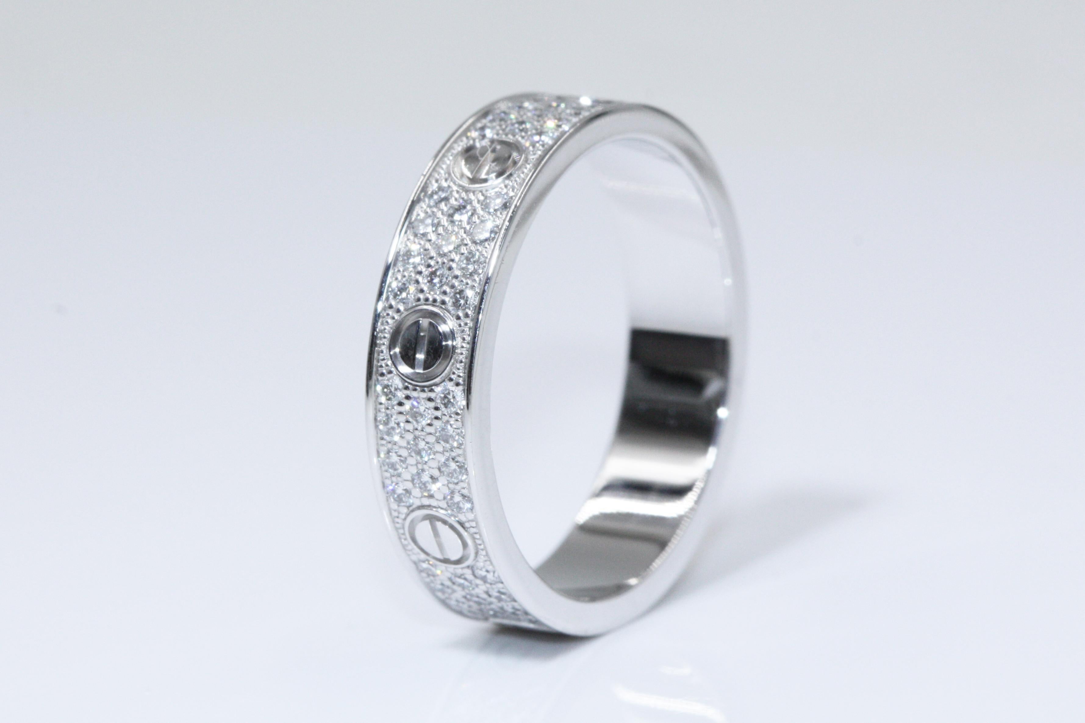 A beautiful Love Wedding band diamond ring from Cartier. The ring is made in 18K white gold set with paved diamonds. REF: B4083454

Ring Measurement: 
Weight: approximate 3.83g
Width: approximate 4.00mm
Size EU 49 US 4.75
This item will come with an