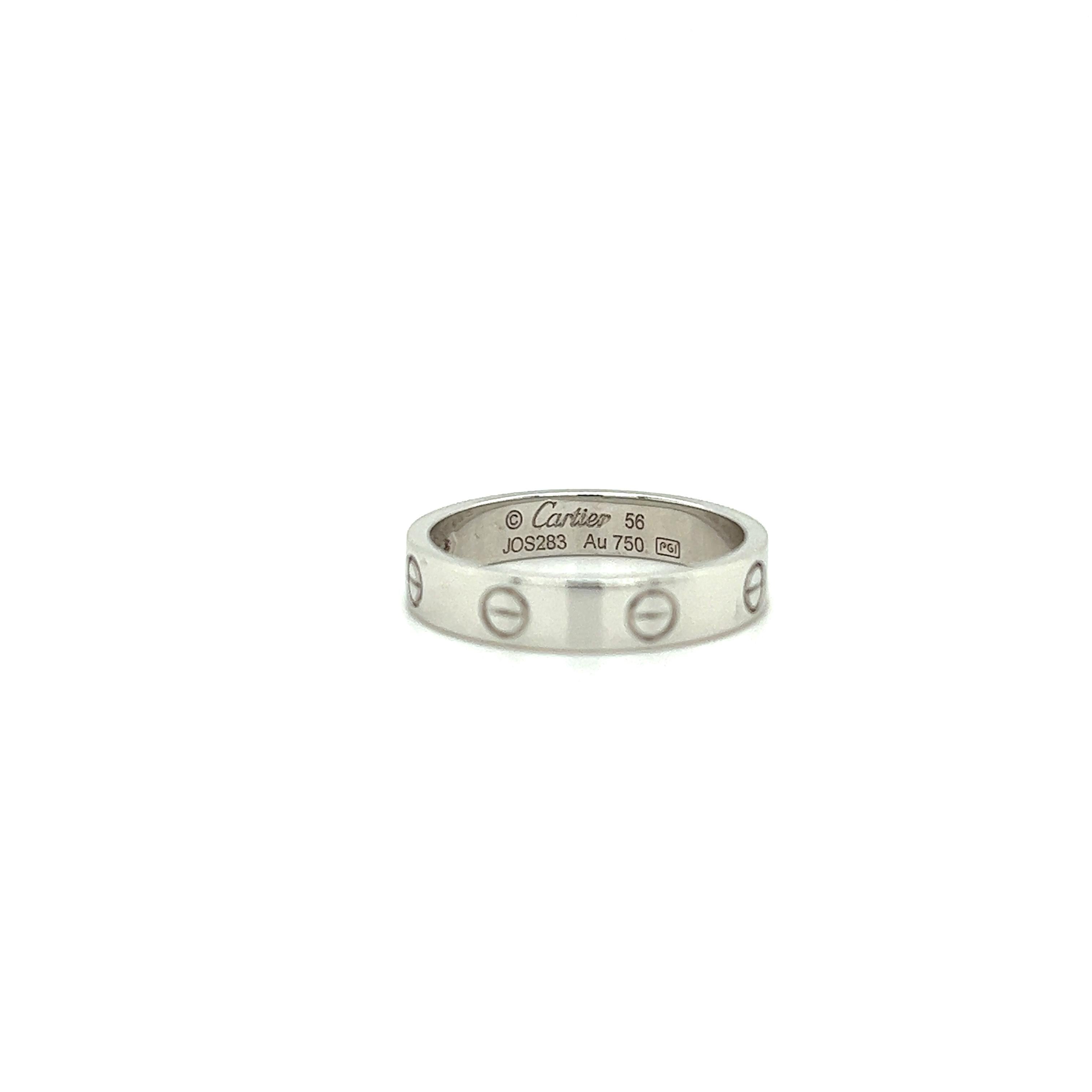 Beautiful timeless creation from Cartier.
This elegant wedding band is crafted in 18k white gold. The ring is set with one earth mined natural round brilliant cut diamond weighing 0.02 carat. 
The ring is a size 56 or 7.5 and fully hallmarked by