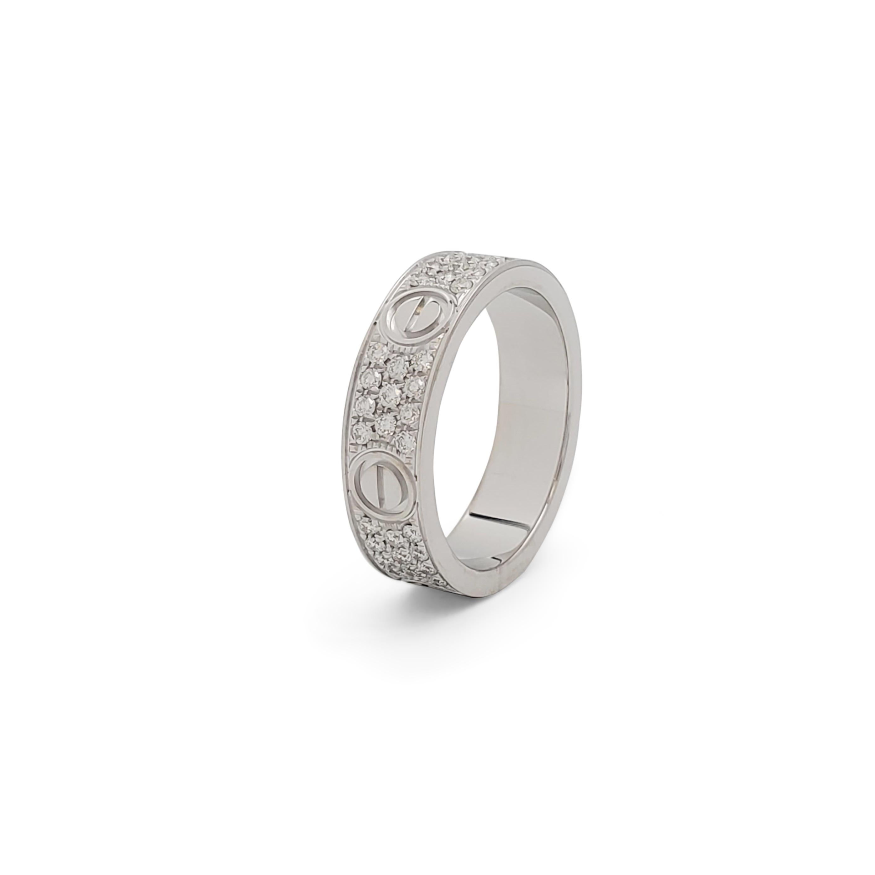 Authentic iconic Cartier 'Love' ring crafted in 18 karat white gold is pave set with an estimated 0.66 carats of high-quality round brilliant cut diamonds (E-F, VS). Signed Cartier, 59, Au750, with serial number and hallmark. Ring size 59 (US 8