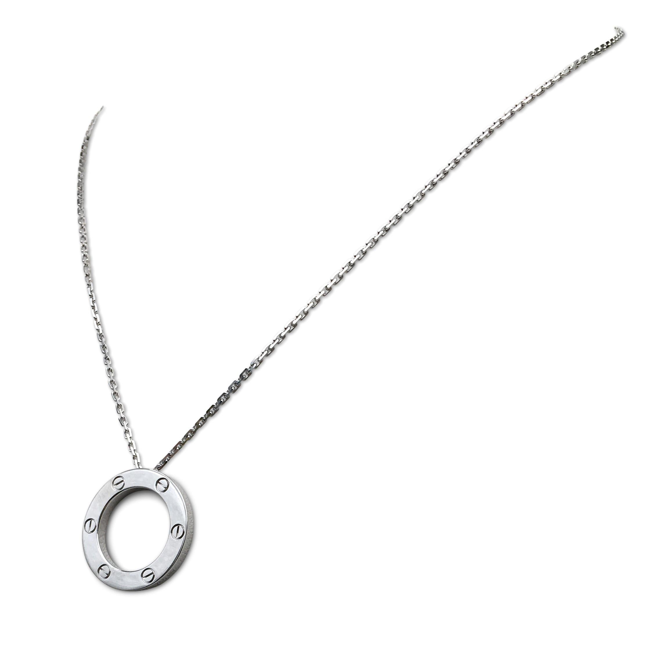 Authentic Cartier Love pendant necklace crafted in 18 karat white gold. The 24 mm pendant features classic crew top motif on one side and 'LOVE' spelled out on the other. Pendant hangs from a white gold oval link chain that is 17 inches in length.