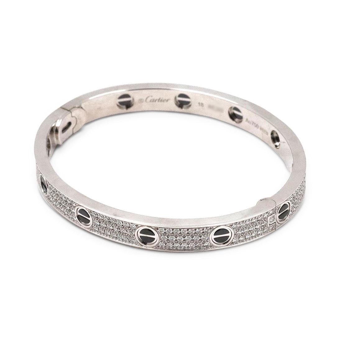 Authentic Cartier 'Love' bangle bracelet crafted in 18 karat white gold with black ceramic screw tops and set with brilliant cut diamonds (D-F in color, VVS clarity) weighing an estimated 2 carats total. Signed Cartier, size 18, Au750, with serial