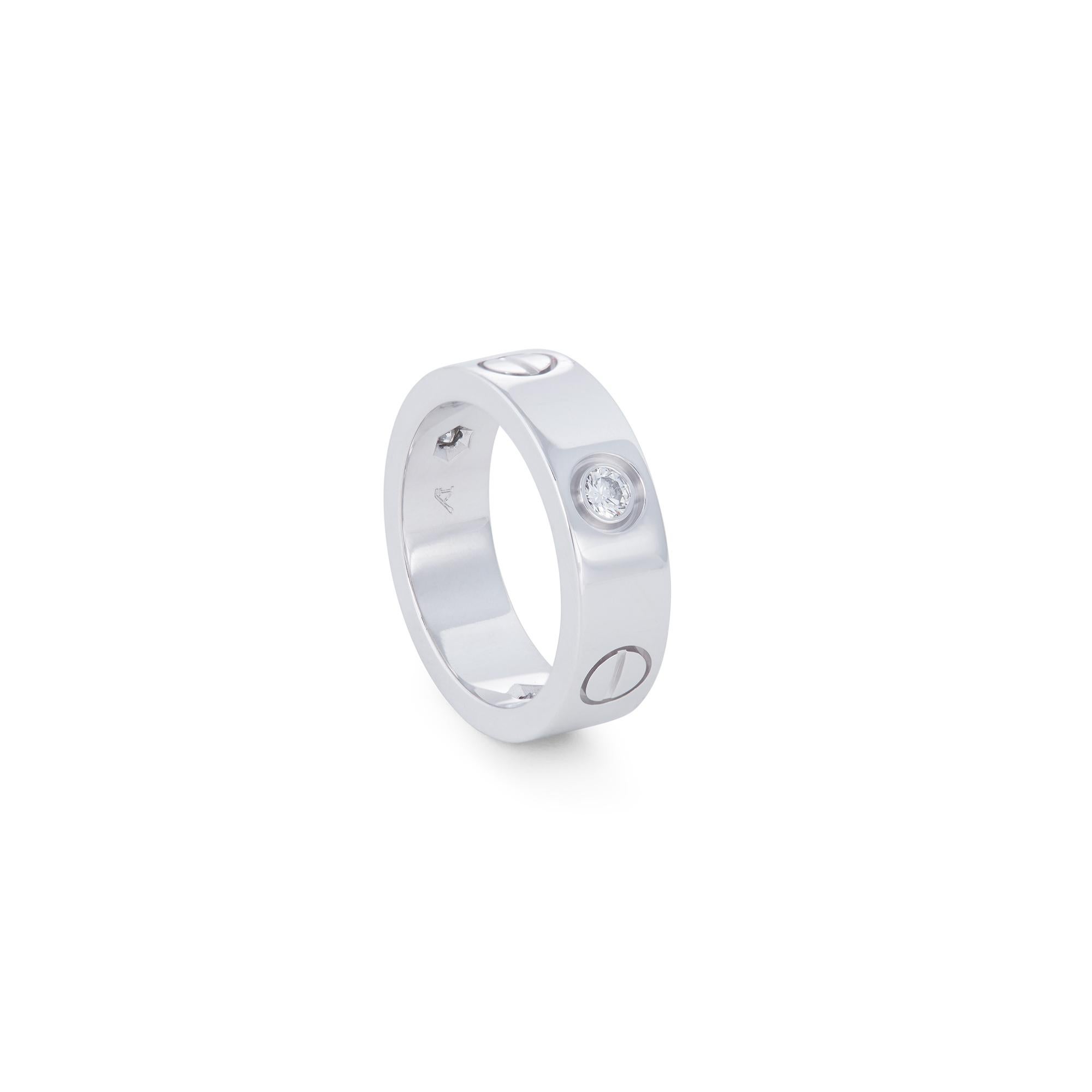 Authentic Cartier 'Love' ring crafted in 18 karat white gold and set with three high-quality round brilliant cut diamonds weighing an estimated 0.22 carats total weight. Ring size 49 (US 4 3/4). Signed Cartier, Au 750, 1998 with serial number and