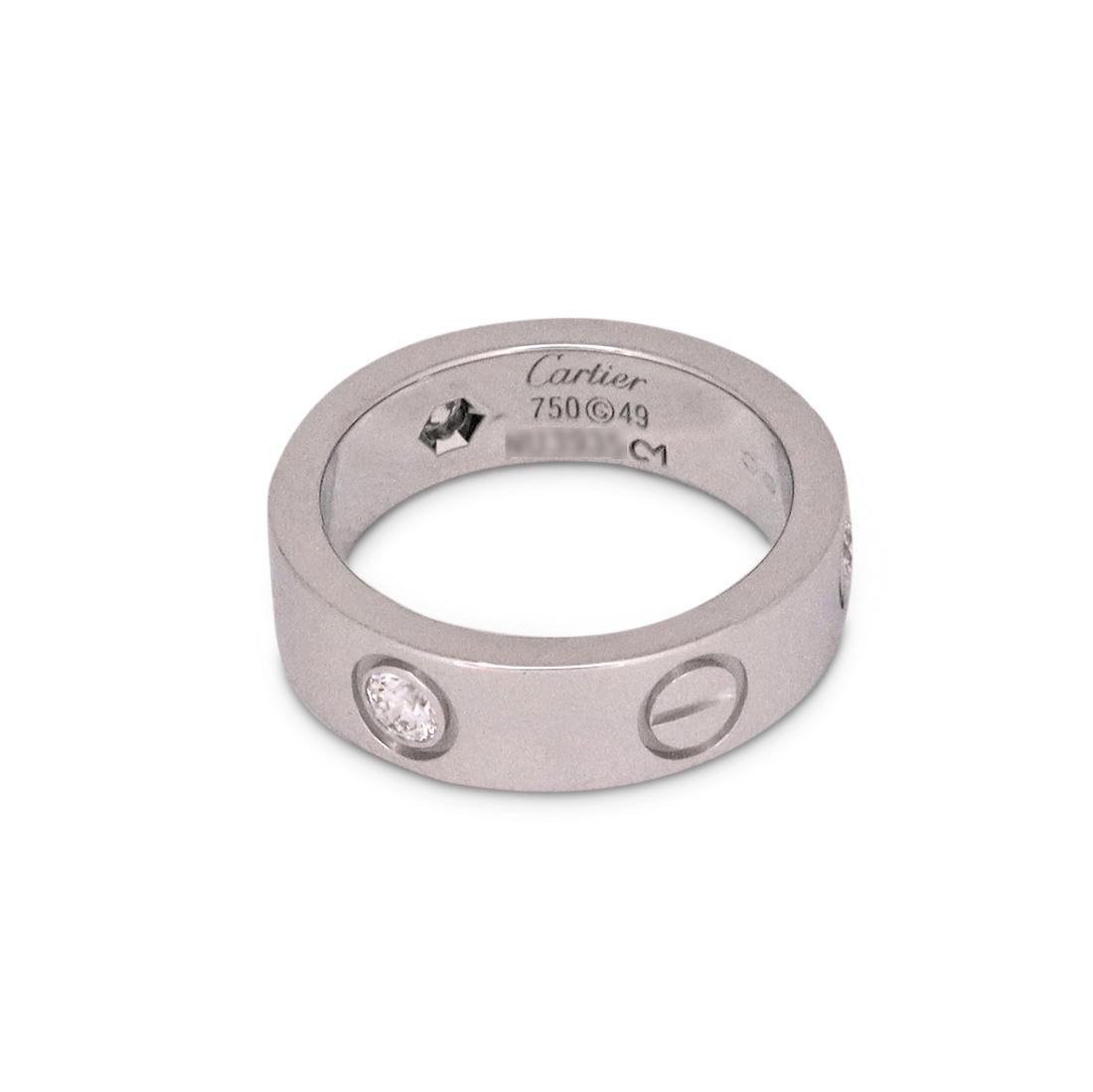 Authentic Cartier ‘Love’ Ring crafted in 18 karat white gold and and set with three round brilliant cut diamonds (E-F, VS) weighing an estimated 0.22 carats total weight. Signed Cartier, 49, Au750, with serial number and hallmarks. Size 49 (4 3/4