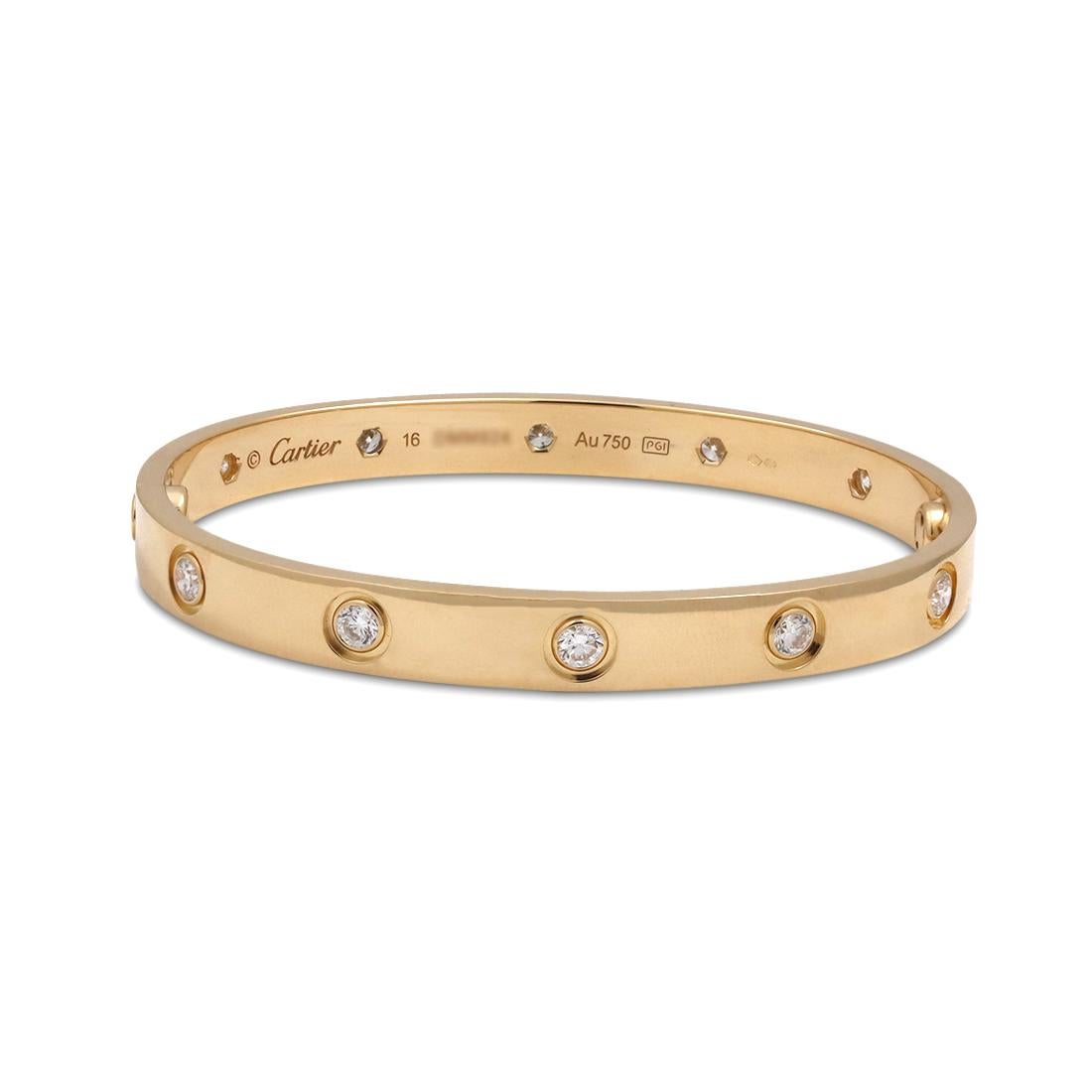 Authentic Cartier 'Love' bangle bracelet crafted in 18 karat yellow gold set with ten round brilliant cut diamonds (E-F in color, VS clarity) weighing an estimated 0.96 carats total. Signed Cartier, size 16, Au750, with serial number and hallmarks.