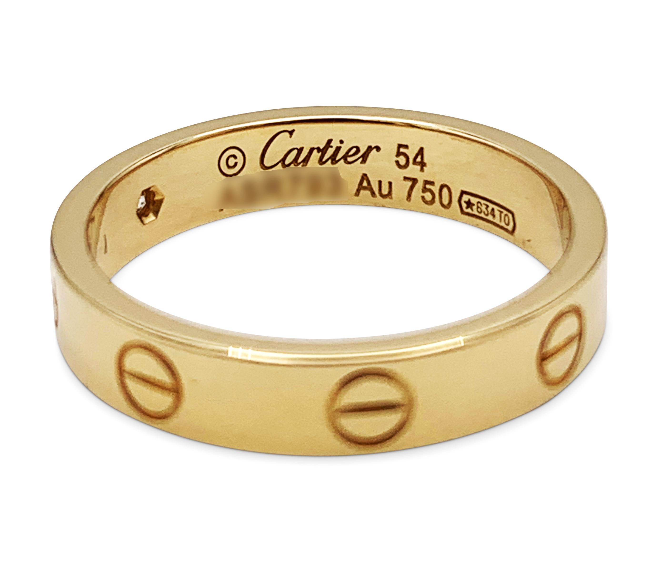 Authentic Cartier Love Ring crafted in 18 karat yellow gold and features 1 round brilliant diamond weighing an estimated .04ct.  Signed Cartier, 54, Au750, with serial number and hallmarks.  Size 54, US size 6 3/4.  The ring is not presented with
