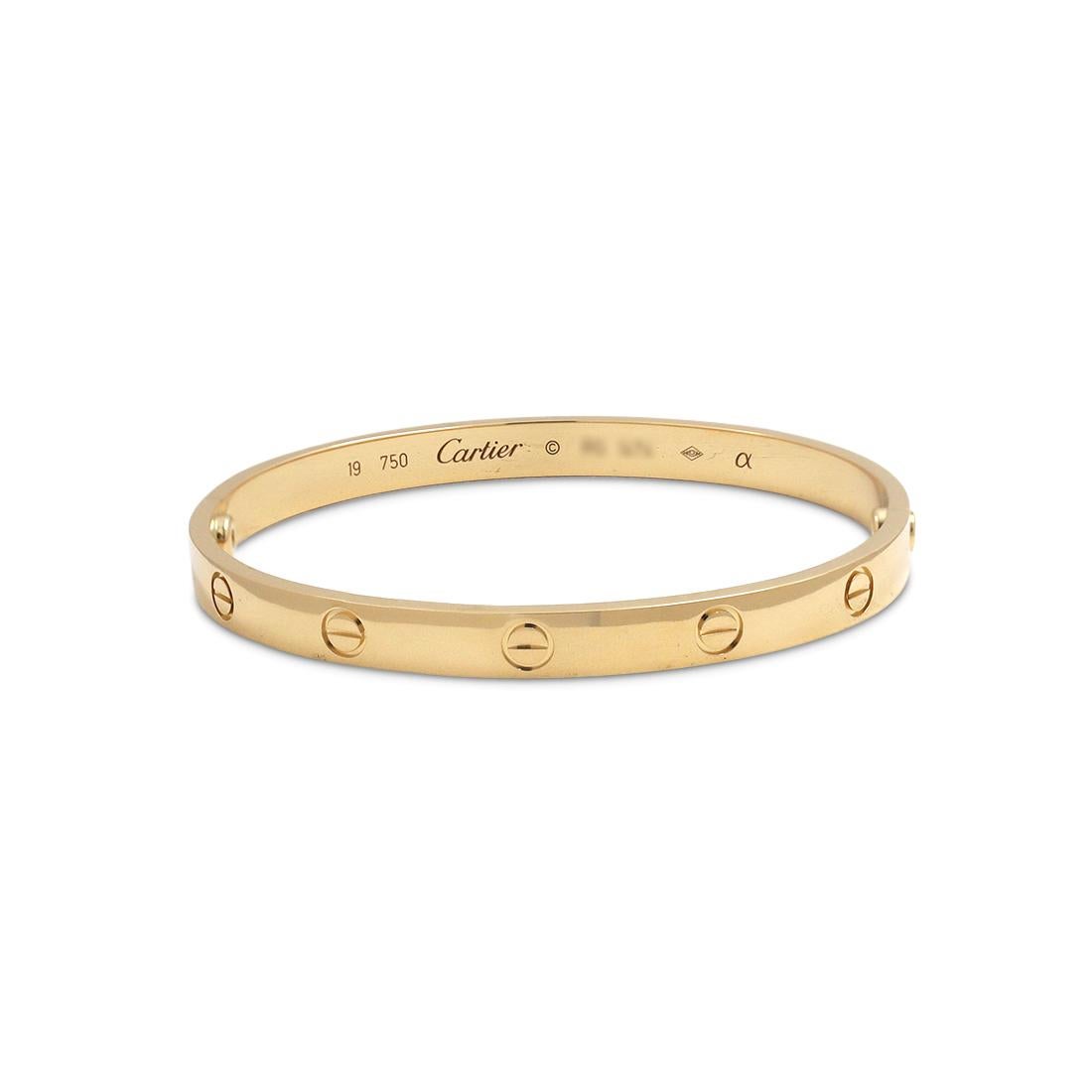 Authentic Cartier 'Love' bracelet crafted in 18 karat yellow gold. Size 19. Signed Cartier, 19, Au750, with serial number and hallmarks. The bracelet is presented with the original screwdriver, Cartier service papers, and no box. CIRCA