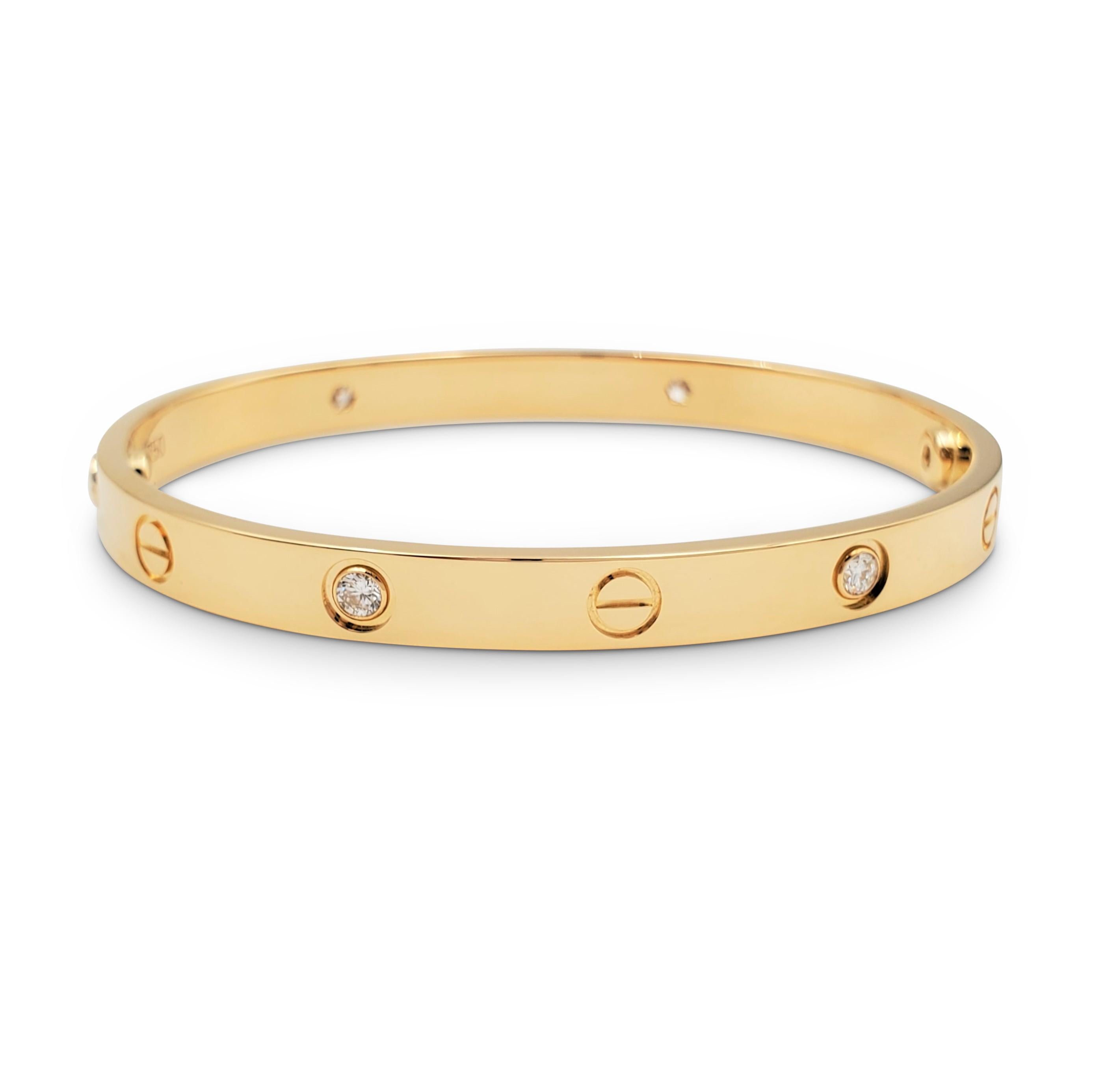 Authentic Cartier 'Love' bracelet crafted in 18 karat yellow gold and set with four high-quality round brilliant cut diamonds (E-F color, VS clarity) weighing an estimated 0.42 carats total. Size 18. Signed Cartier, 750, 18, with serial number and