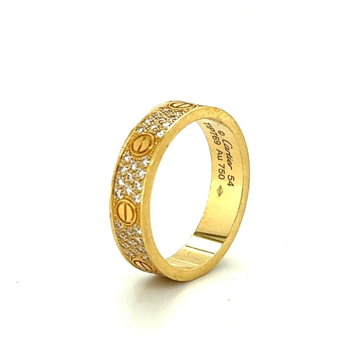 Beautiful ring crafted in 18k yellow gold. This ring is crafted by famed designer Cartier and set with 88 round brilliant cut diamonds throughout. The ring shows a 4.8 mm width and is a size 54 or 6.75.
The ring is fully hallmarked by the designer