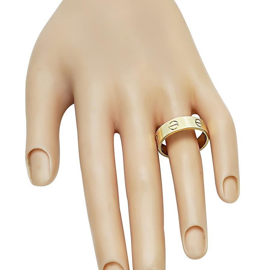 This is an amazing 18k yellow gold Cartier love wedding band that features the traditional Cartier screw engravings. The ring is stamped Cartier 750 with serial numbers. The band measures 6mm in width. The band Cartier size is 62 or a ring size of