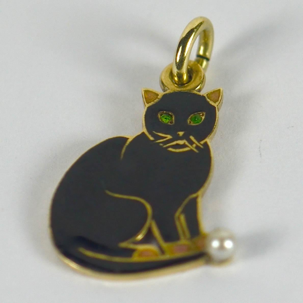 An 18ct gold and enamel charm by Cartier New York designed as a lucky black cat with a natural pearl ball and emerald eyes. Engraved to the reverse 'Ou j'entre le bonheur me suit' meaning 'where I enter happiness follows me'.

Signed Cartier