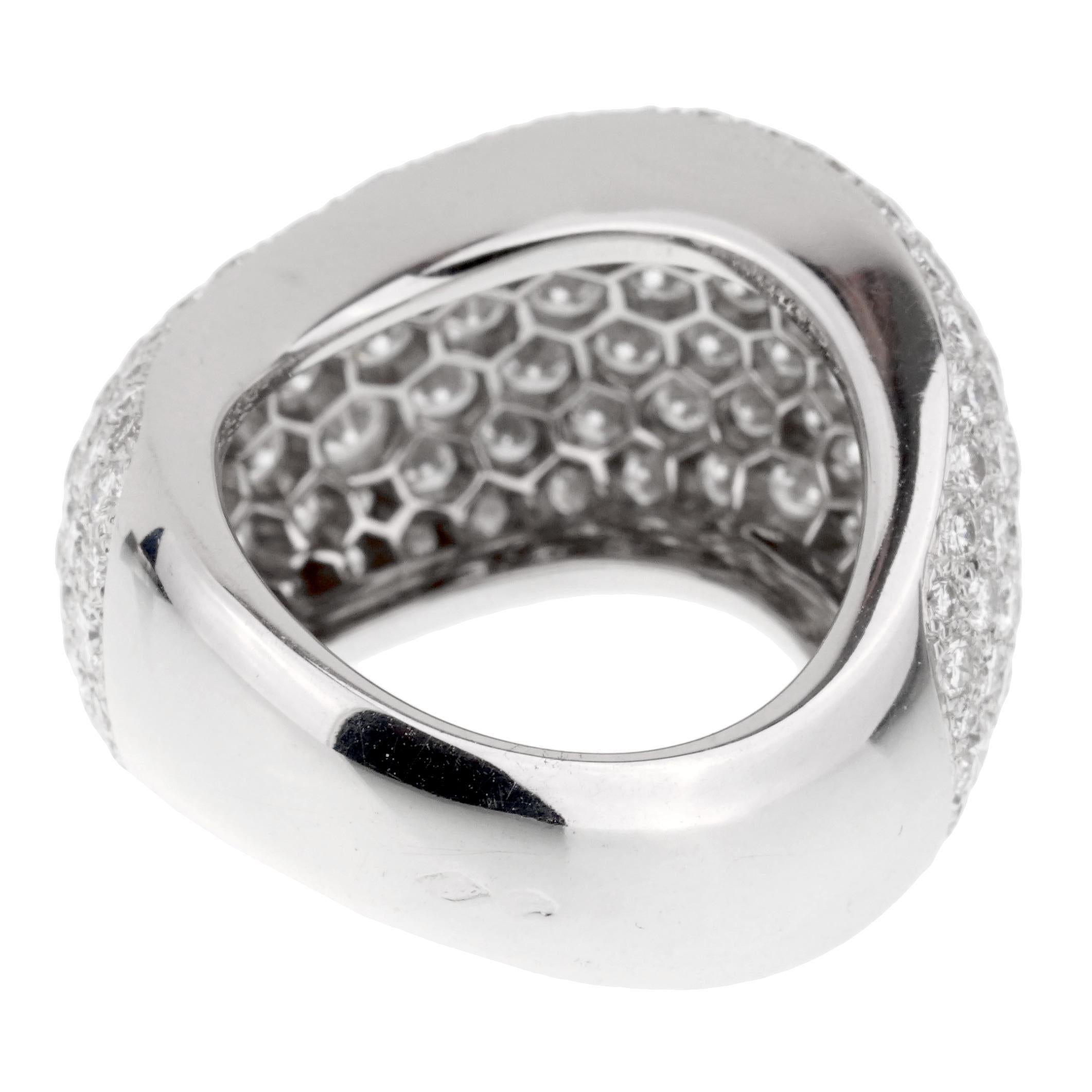 A magnificent authentic Cartier cocktail ring featuring a slightly swirled design set with the finest Cartier round brilliant cut diamonds (5cts appx) in 18k white gold. Size: US 6 Ring Width: .59″ Inches wide
