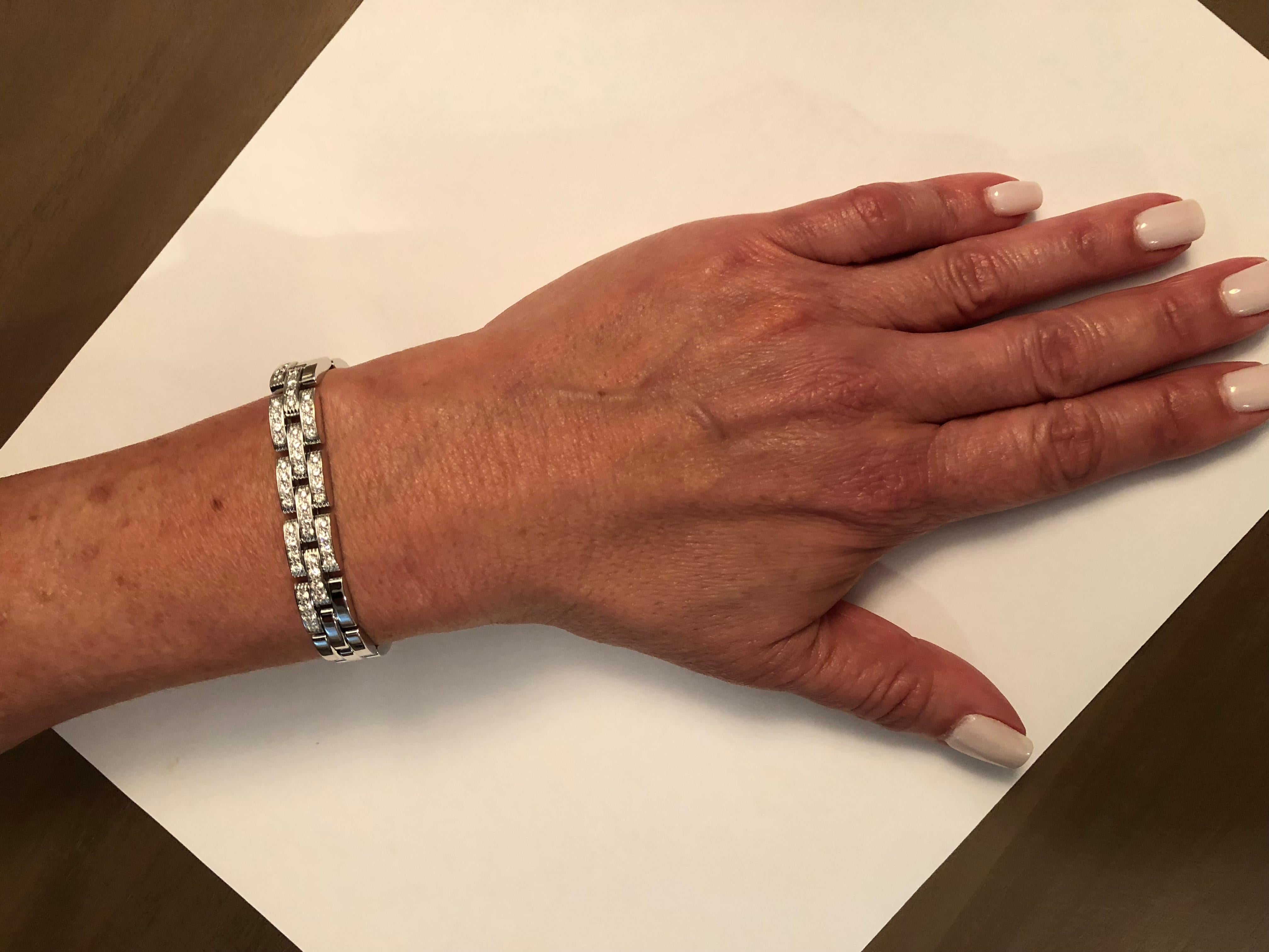 Previously owned Cartier Panthere collection bracelet.  This bracelet is 7 inches in length, made of 18 carat white gold, weighs 40.0 grams.  It also has 48 E/F color, VS clarity diamonds weighing approximately .96 carats.  It is in beautiful