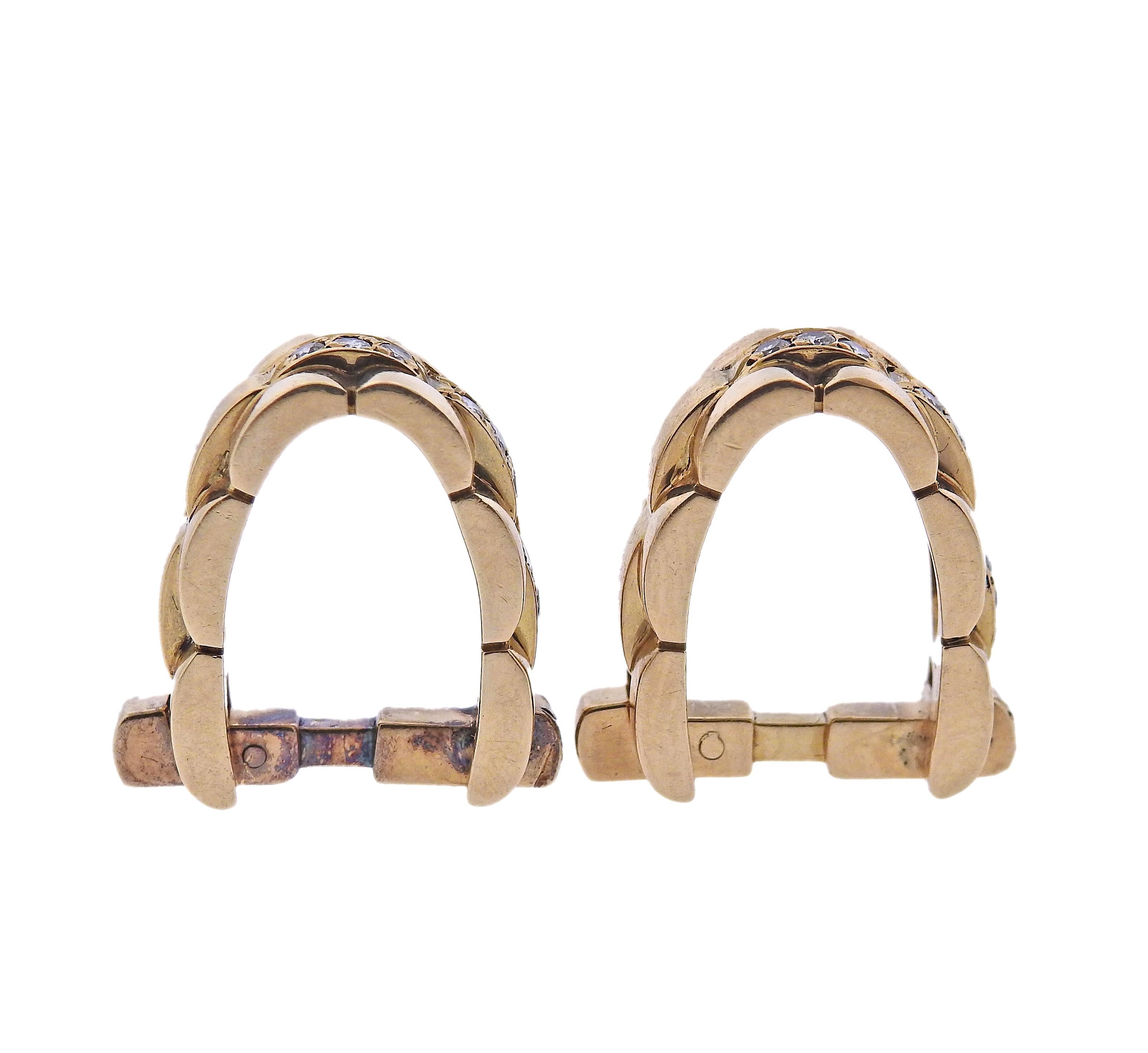 Pair of 18k gold stirrup cufflinks by Cartier, designed in signature Maillon Panthere link design, adorned with approx. 0.30ctw in G/VS diamonds. Each cufflink measures 20mm x 8mm. Marked: 761930, Cartier, 750. Weight - 14.4 grams.