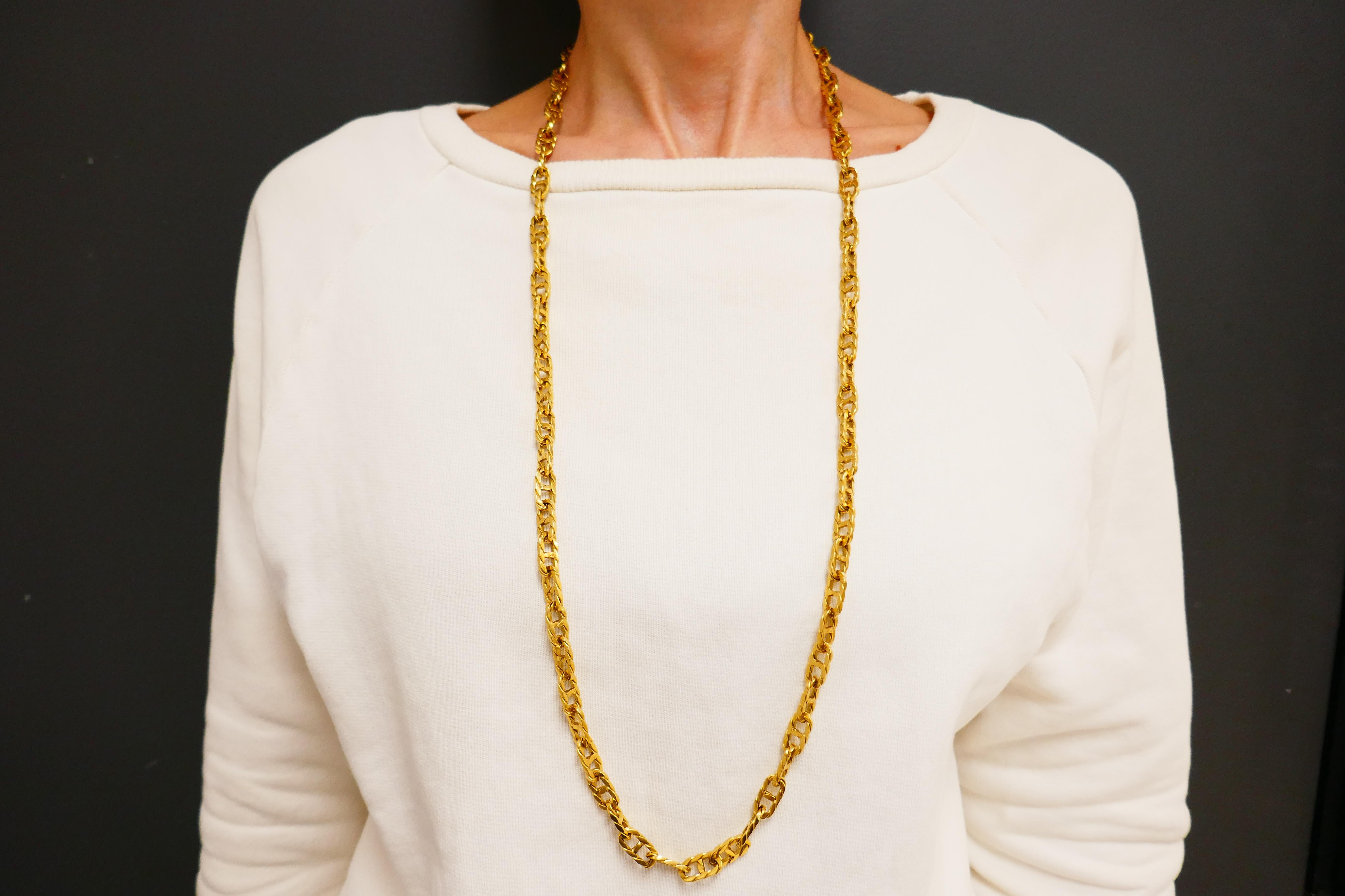 A substantial 18k gold mariner link chain necklace by Cartier.
The links are flat and textured. The chain is 34