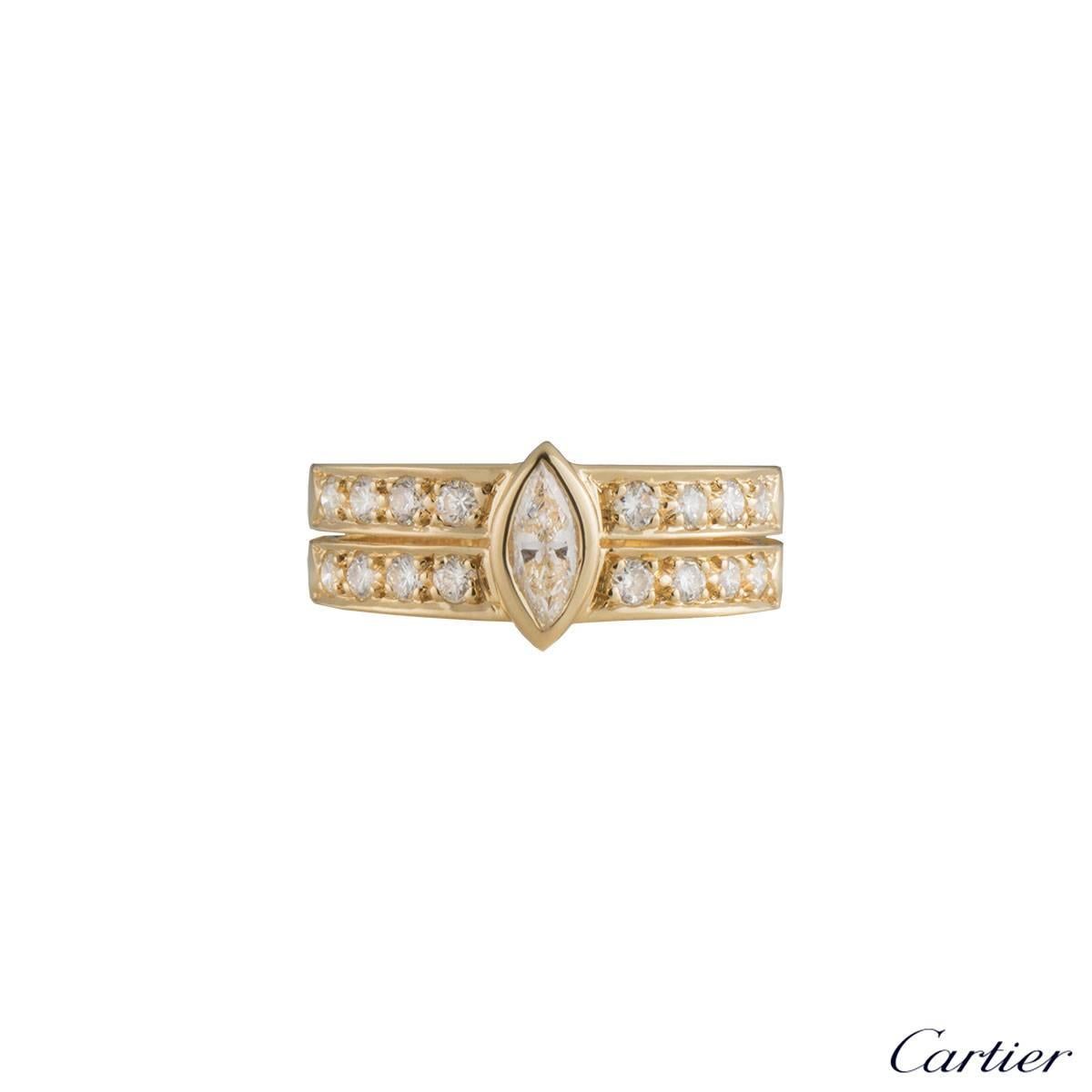A unique 18k yellow gold diamond Cartier ring. The ring comprises of a marquise cut diamond in a rubover setting with a total weight of approximately 0.35ct, predominantly G colour and VS clarity. Complementing the centre stone are two rows of 4