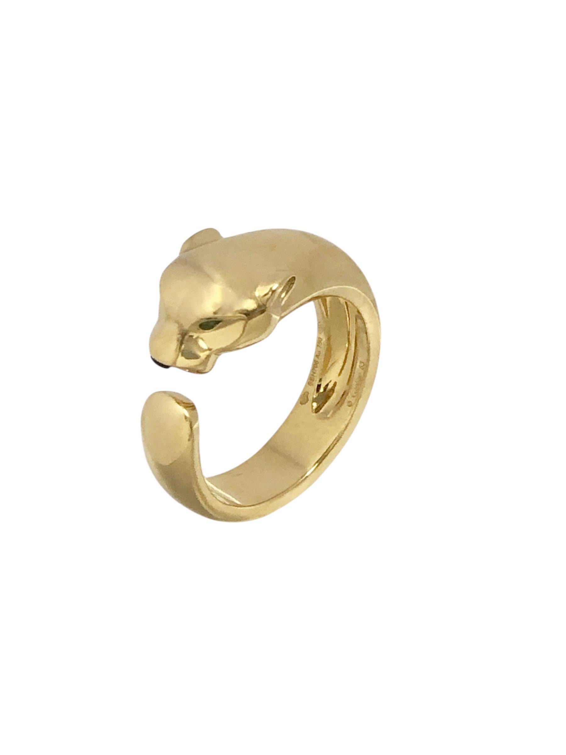 Circa 2010 Cartier Massai Panther 18K Yellow Gold Ring, accented with Emerald Eyes, finger size 10 1/2 Euro size 63, weighing 17.6 Grams. Comes in original Cartier presentation box.