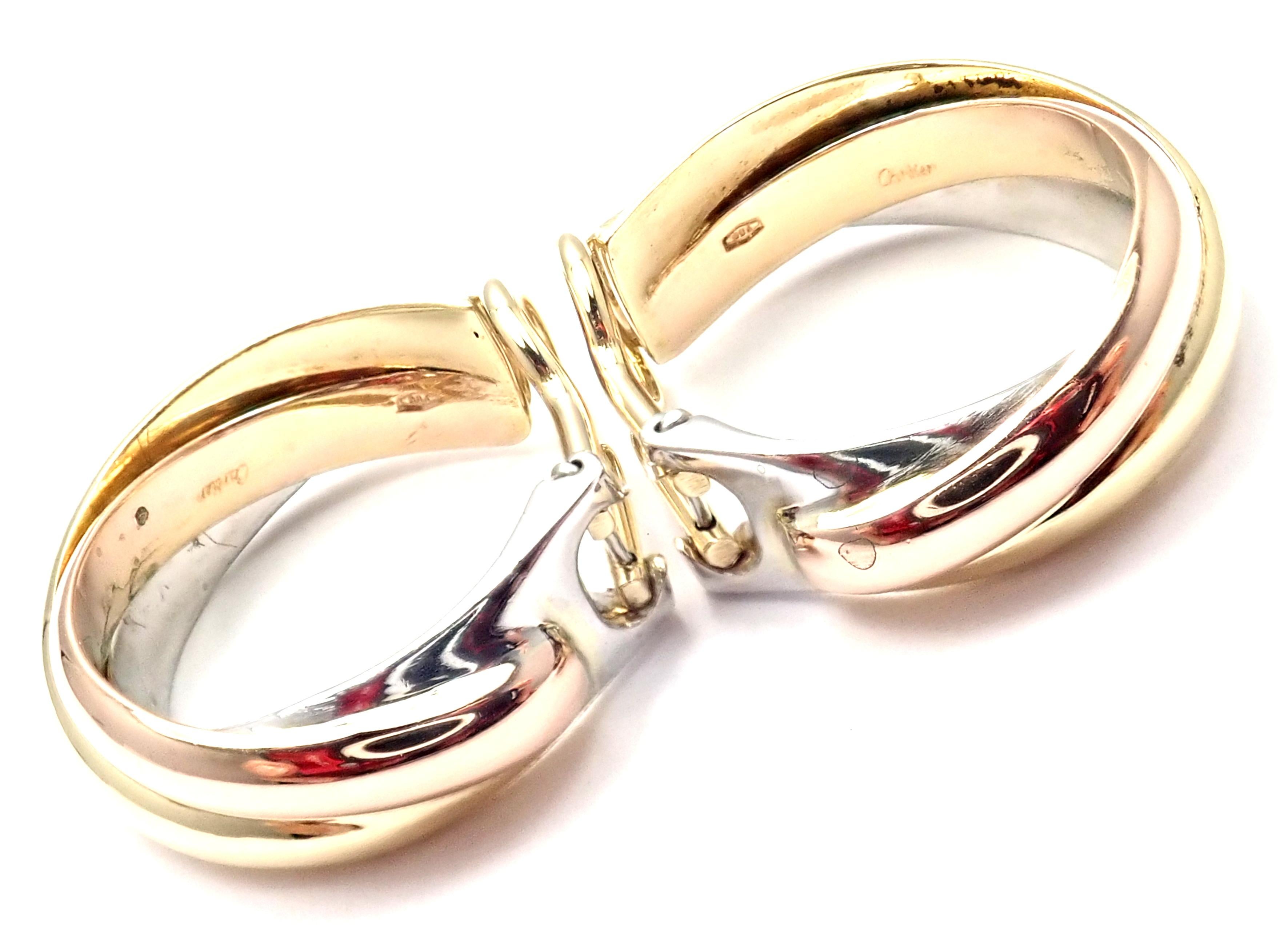 18k Tri-Color (Yellow, White, Rose) Gold Medium Size Trinity Hoop Earrings by Cartier. 
These earrings are for non pierced ears, but they can be converted by adding posts.
Details: 
Measurements: 24mm x 22mm x 7mm
Weight: 18.1 grams
Stamped