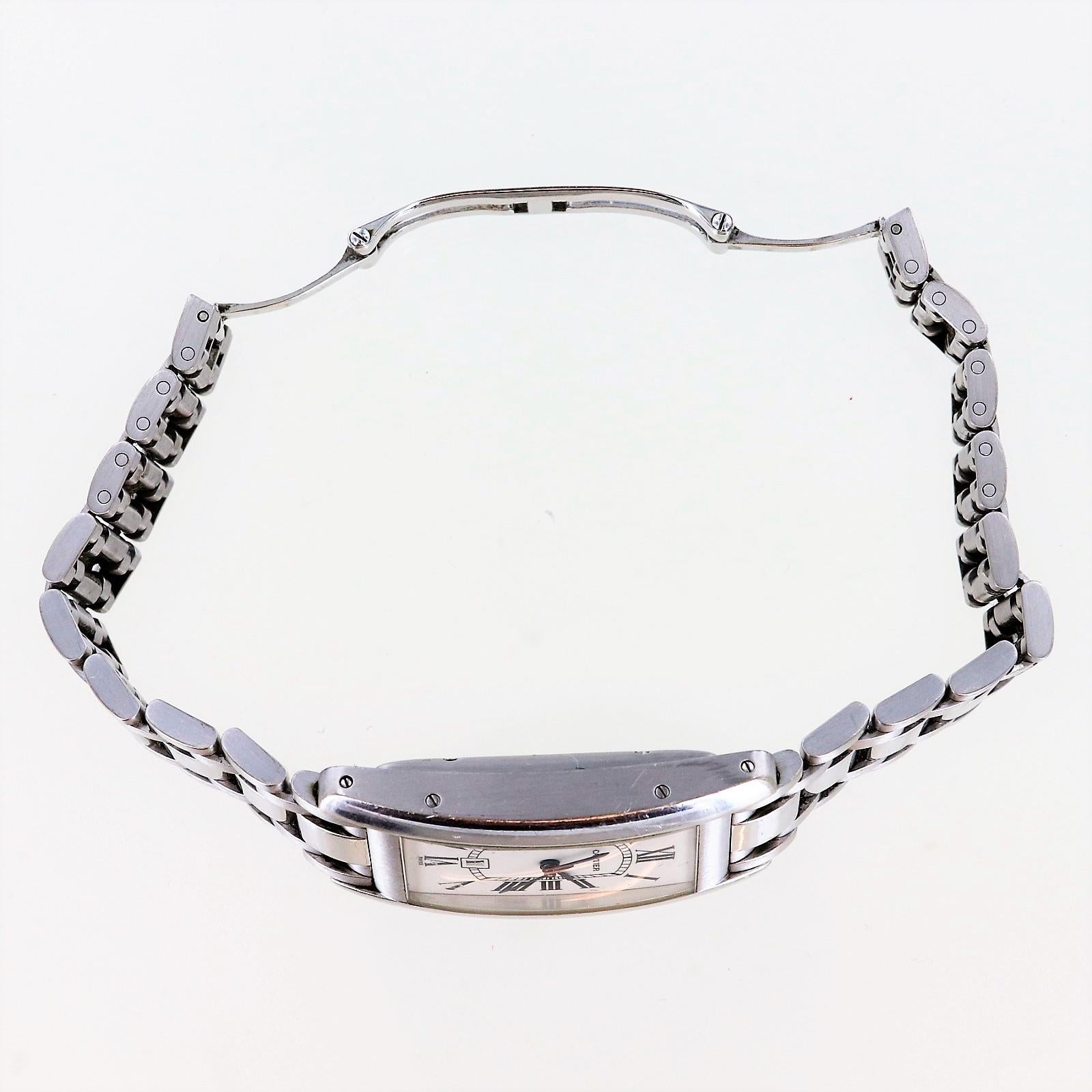 Curved case with blued steel hour, minute and second hands.
Inner minute railtrack. Natural blue sapphire winder.
18ct white gold bracelet.
Signed Cartier. Numbered.