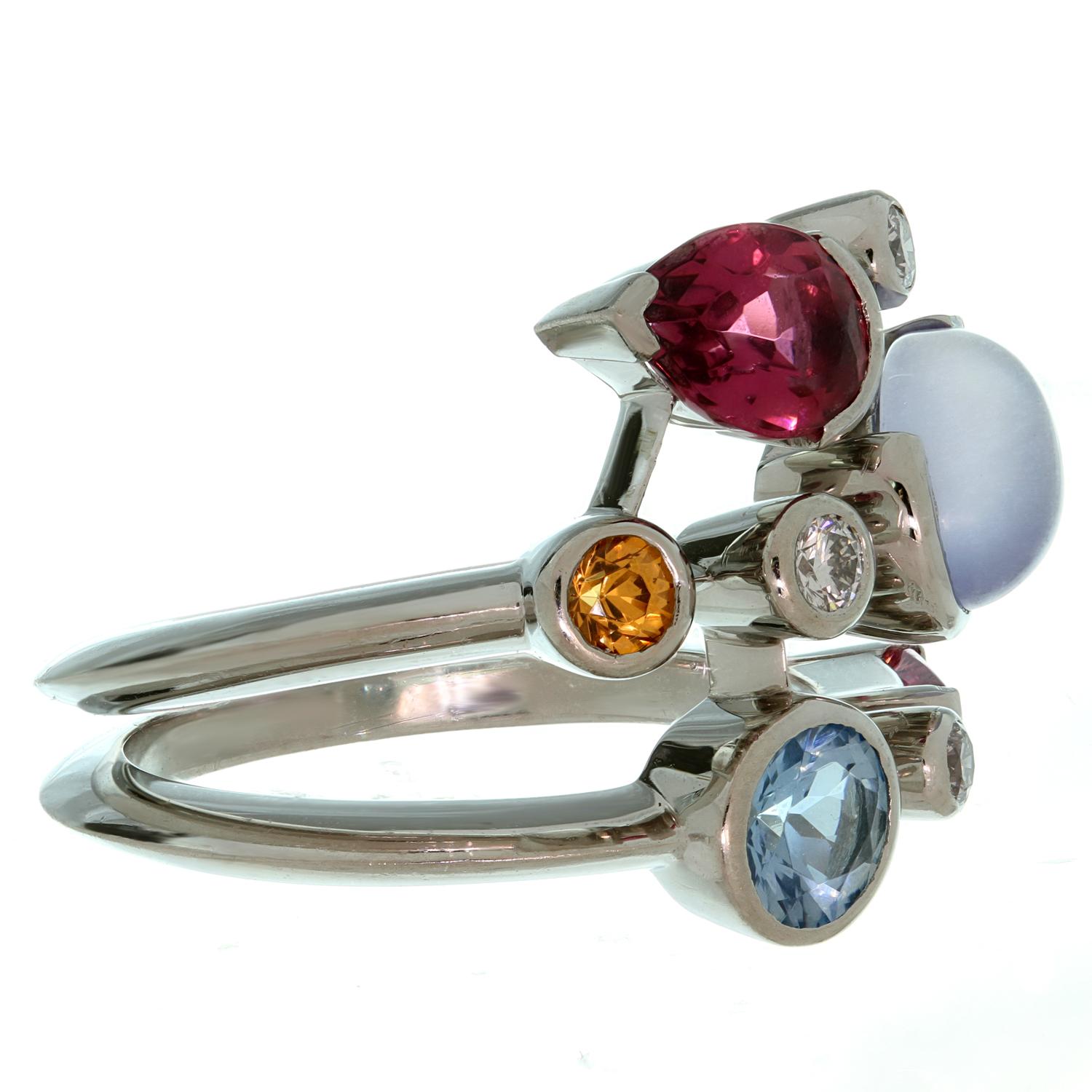 This fabulous Cartier ring from the vibrant Meli Melo collection is crafted in platinum and features 8 gemstones abstractly placed over 3 rows, consisting of diamonds, aquamarine, chalcedony, garnet and pink tourmaline. There are 3 round brilliant