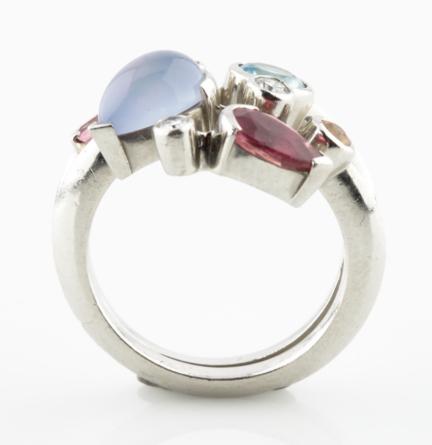 Gorgeous & Unique Cartier Ring. The Meli Melo design features variously polished and faceted gemstones bezel-set in 950 platinum.
The design incorporates aquamarine, pink tourmaline, chalcedony, and mandarin garnet with brilliant-cut diamond
