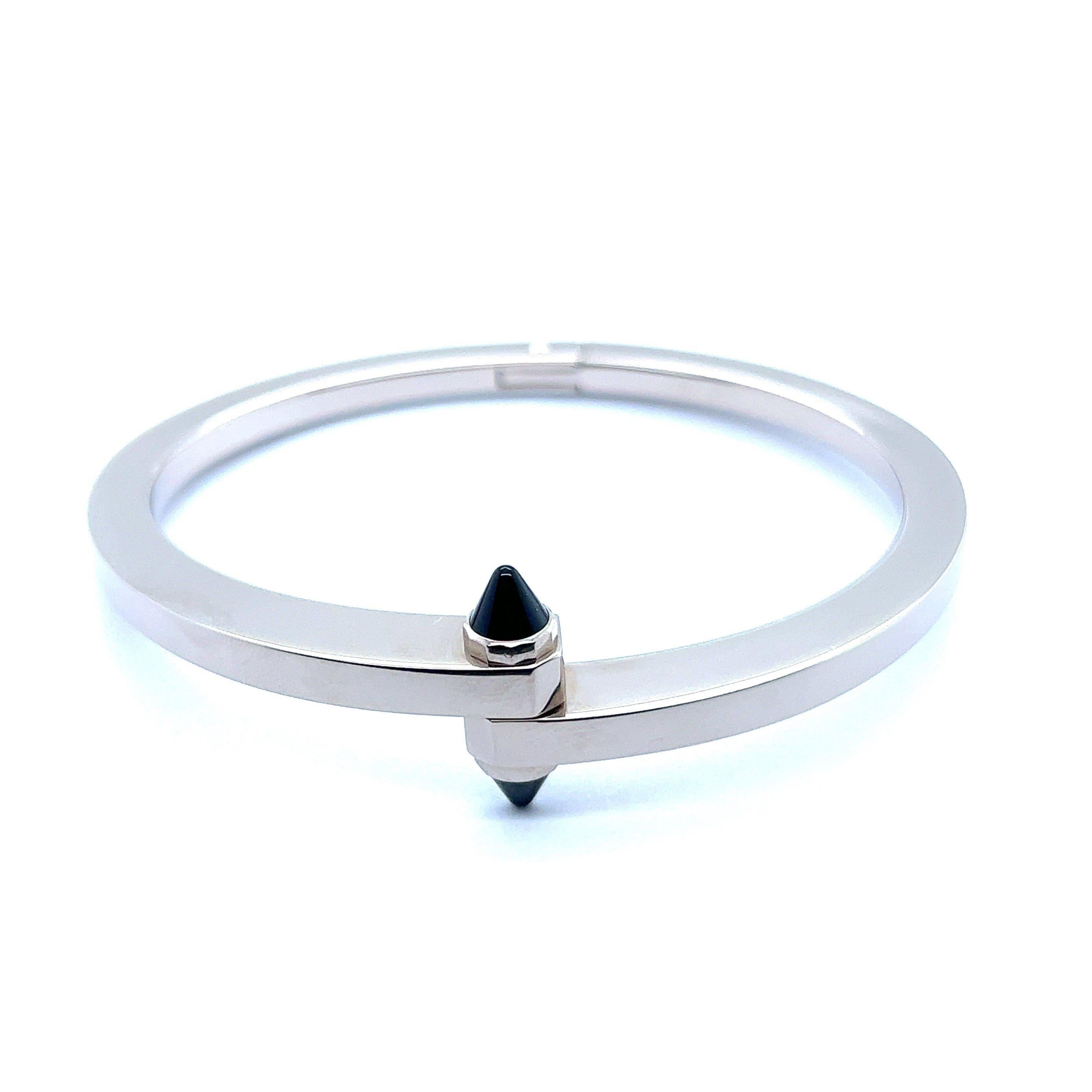 A truly rare find for connoisseurs and discerning collectors – unique bracelet from Menotte collection created by the luxury French jeweler Cartier. This sleek bangle is crafted in 18 Karat white gold and adorned with two bullet-cut onyx. It is