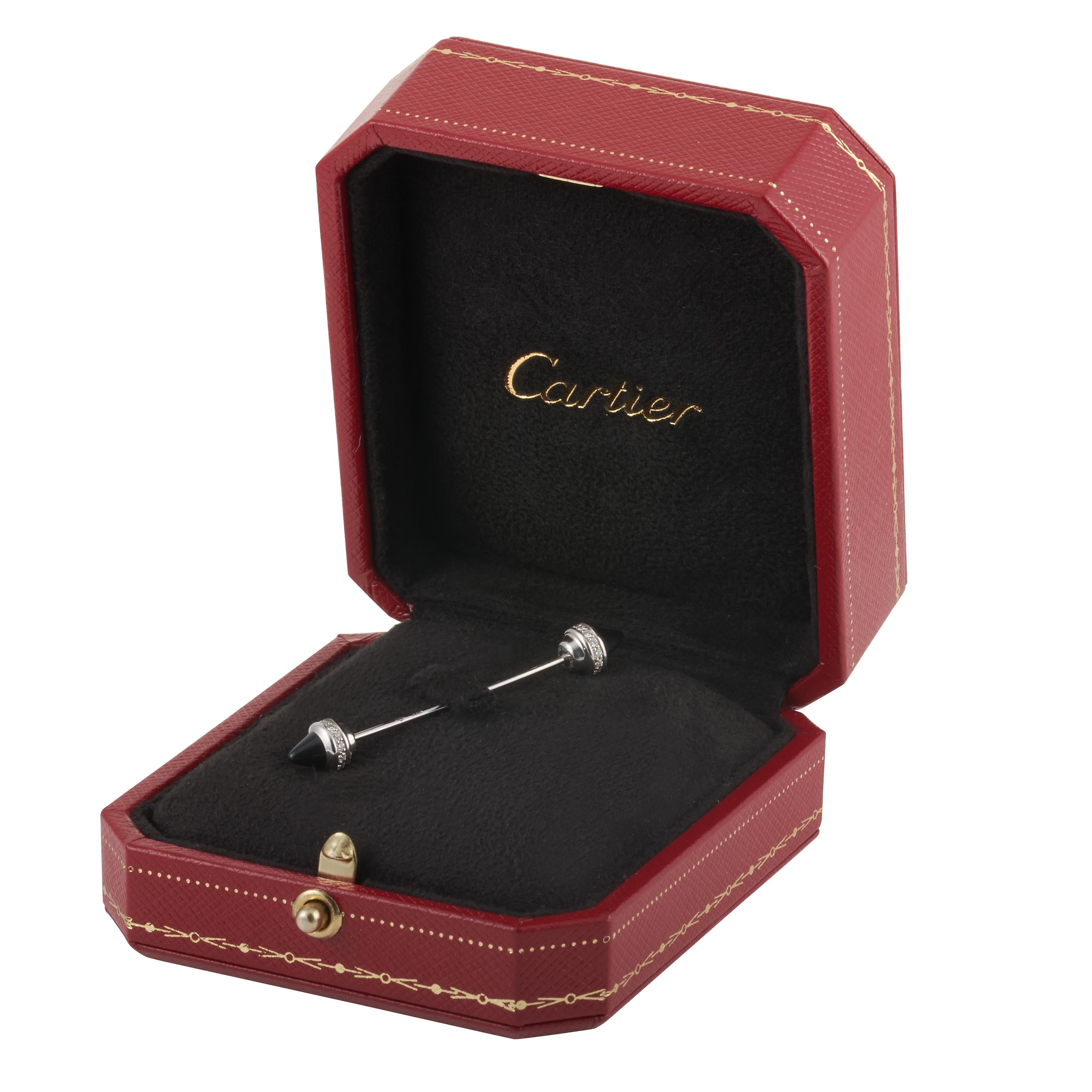 Cartier Menotte diamond and onyx jabot pin in 18kwg accompanied by Cartier box. 

This pin contains 28 round brilliant cut diamonds weighing approximately 0.30 carat with F-G color and VS clarity, accented by two pieces of onyx.

1.96