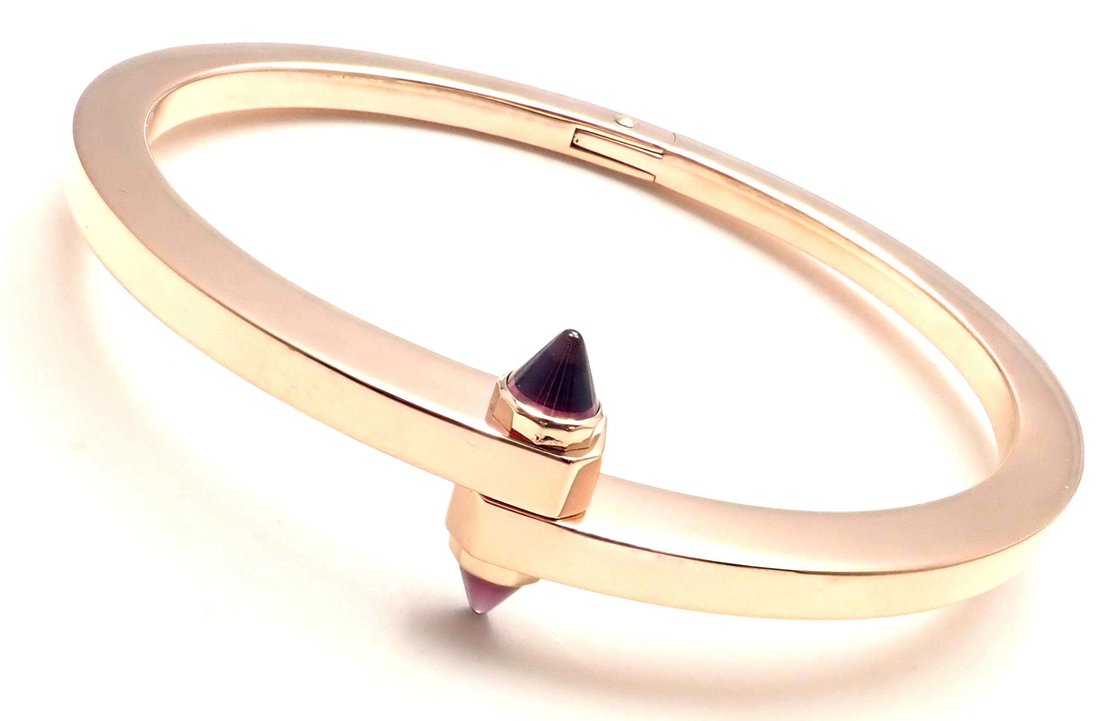 18k Rose Gold Menotte Bangle Bracelet by Cartier. 
This bracelet comes Cartier box and Cartier screwdriver.
2 Rhodolite Garnet stones
Details: 
Size 3, length 6.7 inches
Weight: 50.6 grams
Width: 4mm 
Hallmarks: Cartier 750 CR0473 03
*Free Shipping