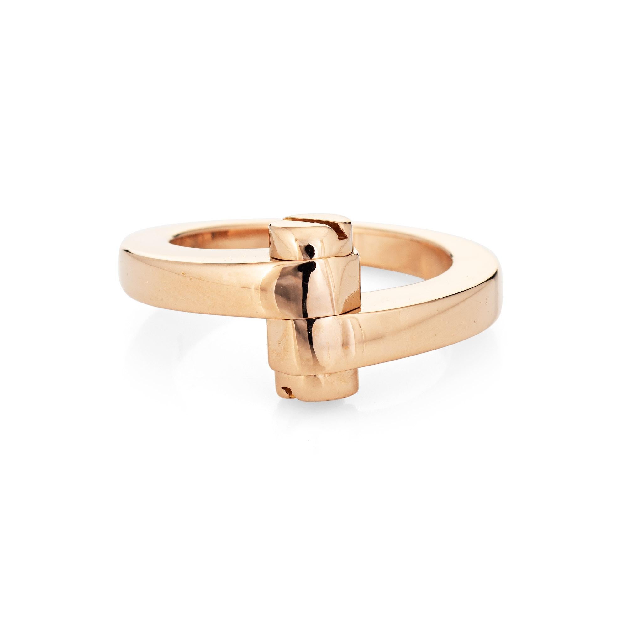 Out of production vintage Cartier 'Menotte' ring crafted in 18k rose gold (circa 1990s).  

The iconic Cartier ring features a bypass design, terminating with two screw head motifs.  The ring is great worn alone or layered with your fine jewelry